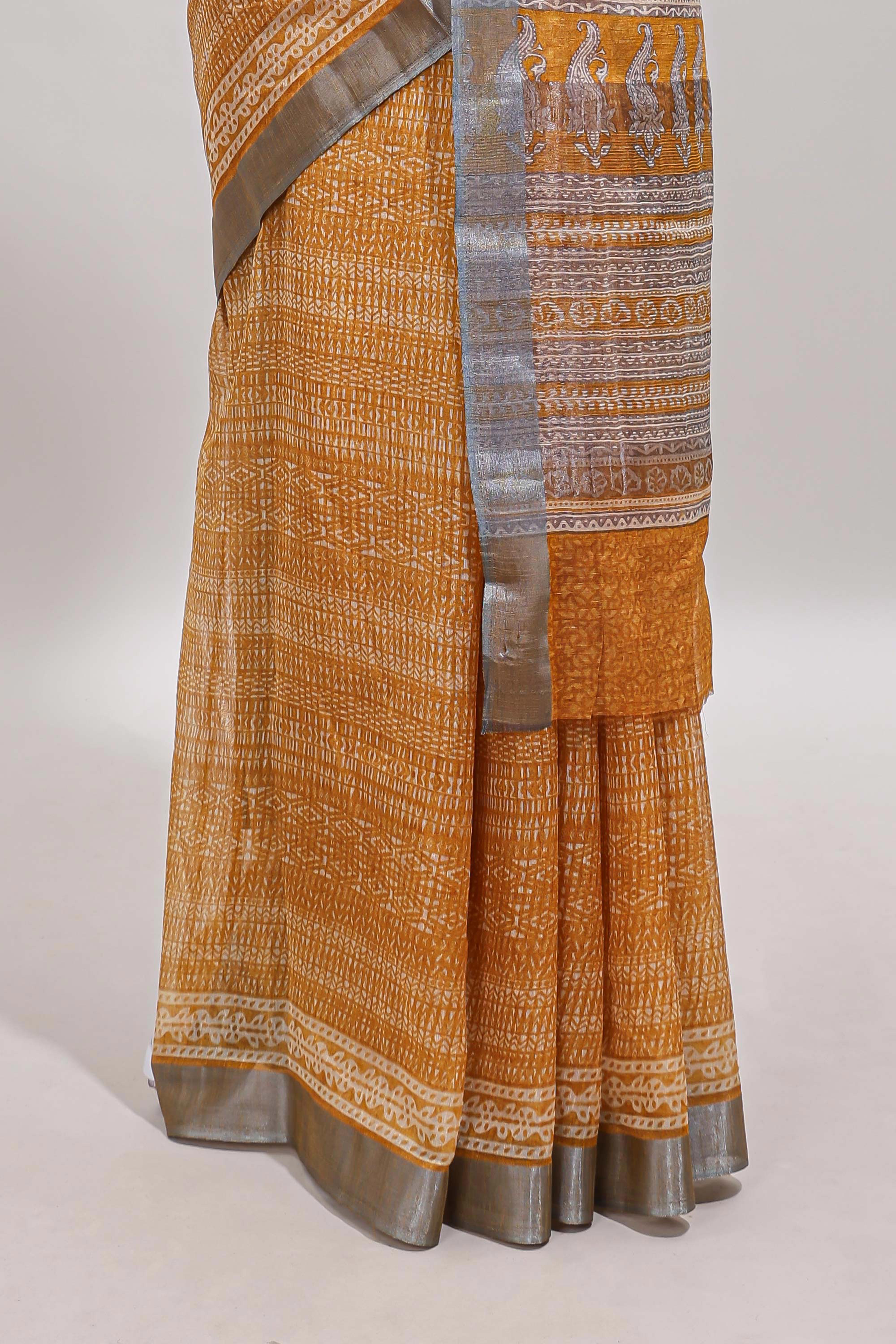 Mustard geometric design semi tussar saree with contrast border and matching blouse