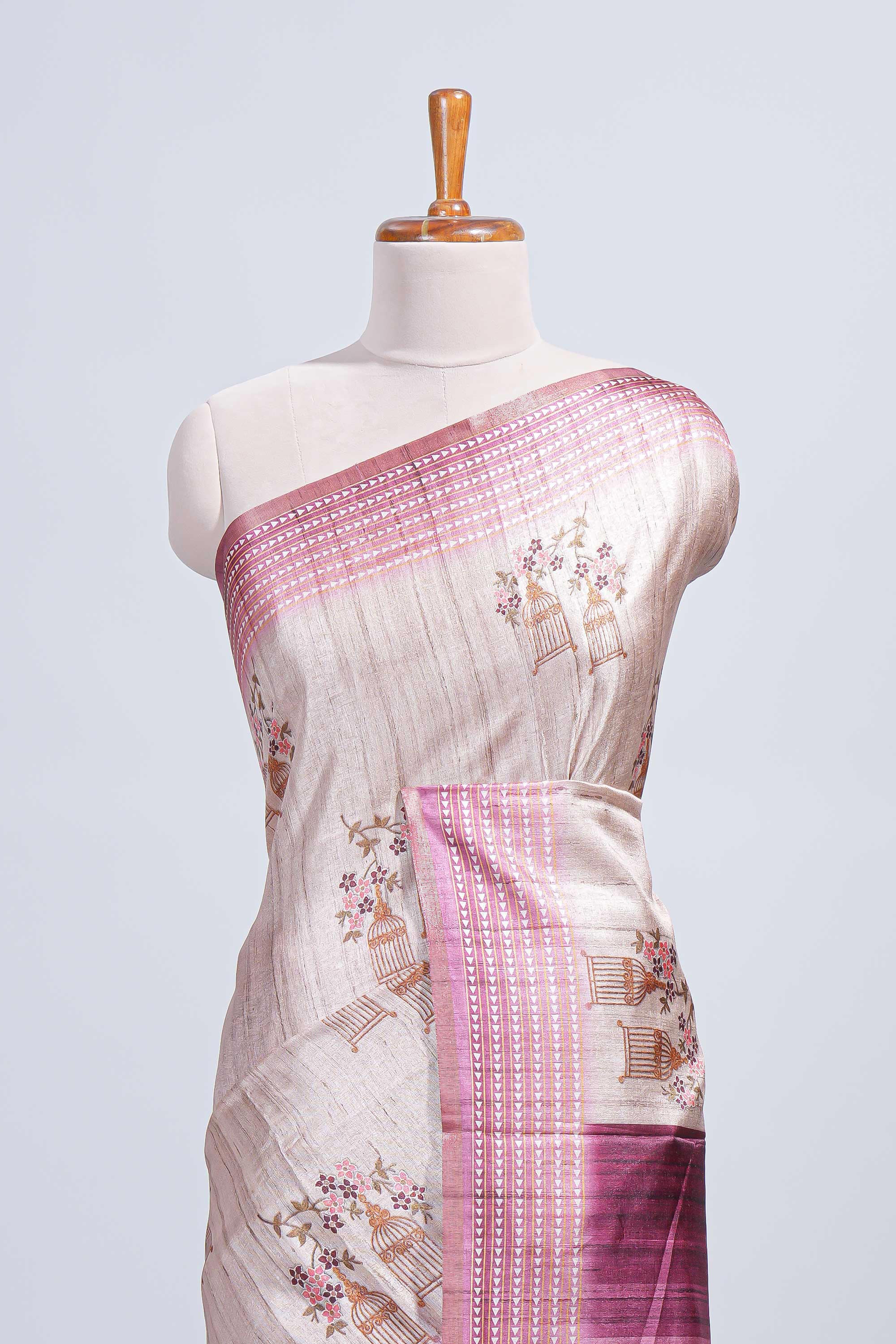 Beige floral & cage print motifs tussar saree with contrast border and blouse