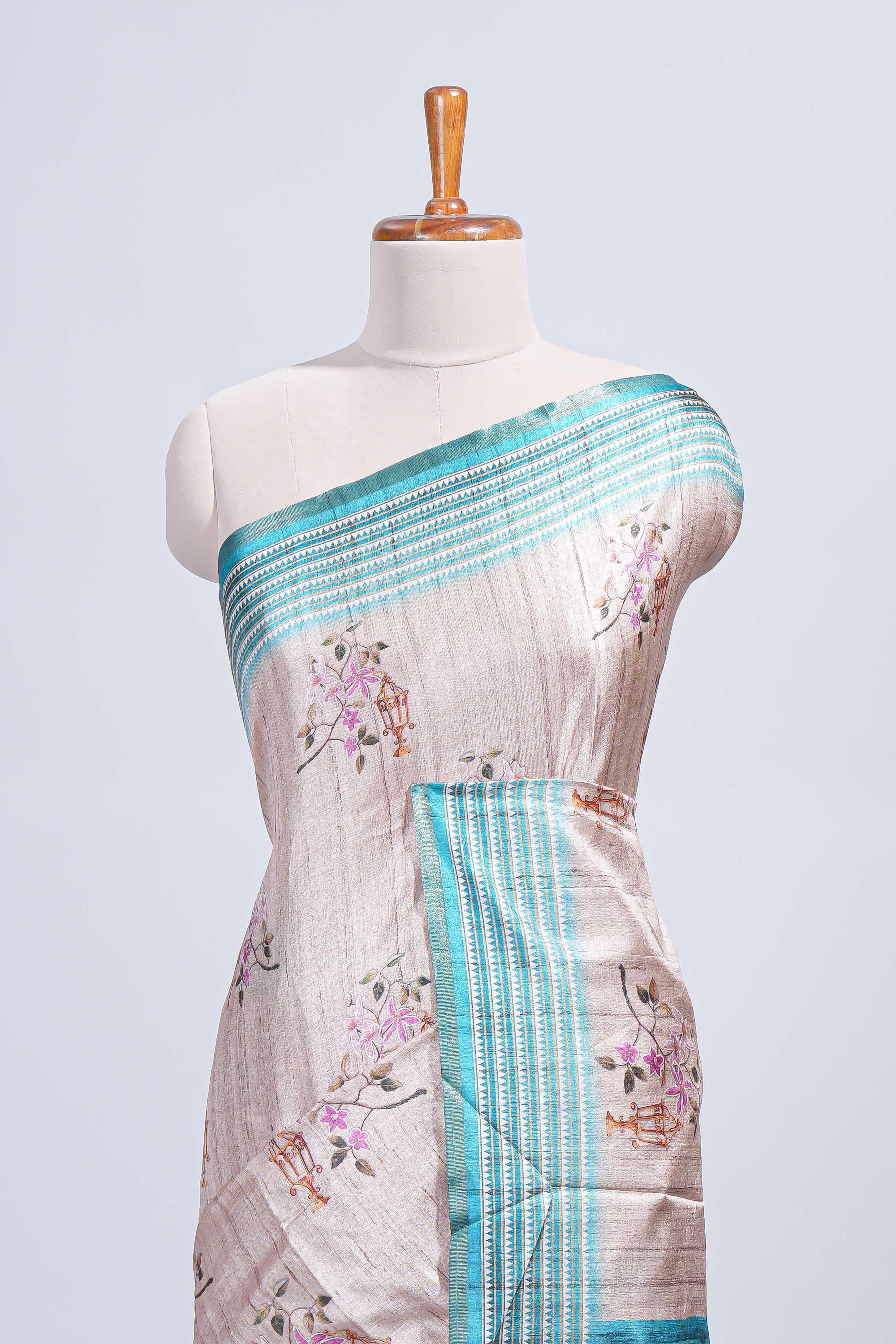 Beige floral & cage print motifs tussar saree with contrast border and blouse