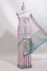 Baby pink geometric design tussar saree with contrast zari border and striped blouse