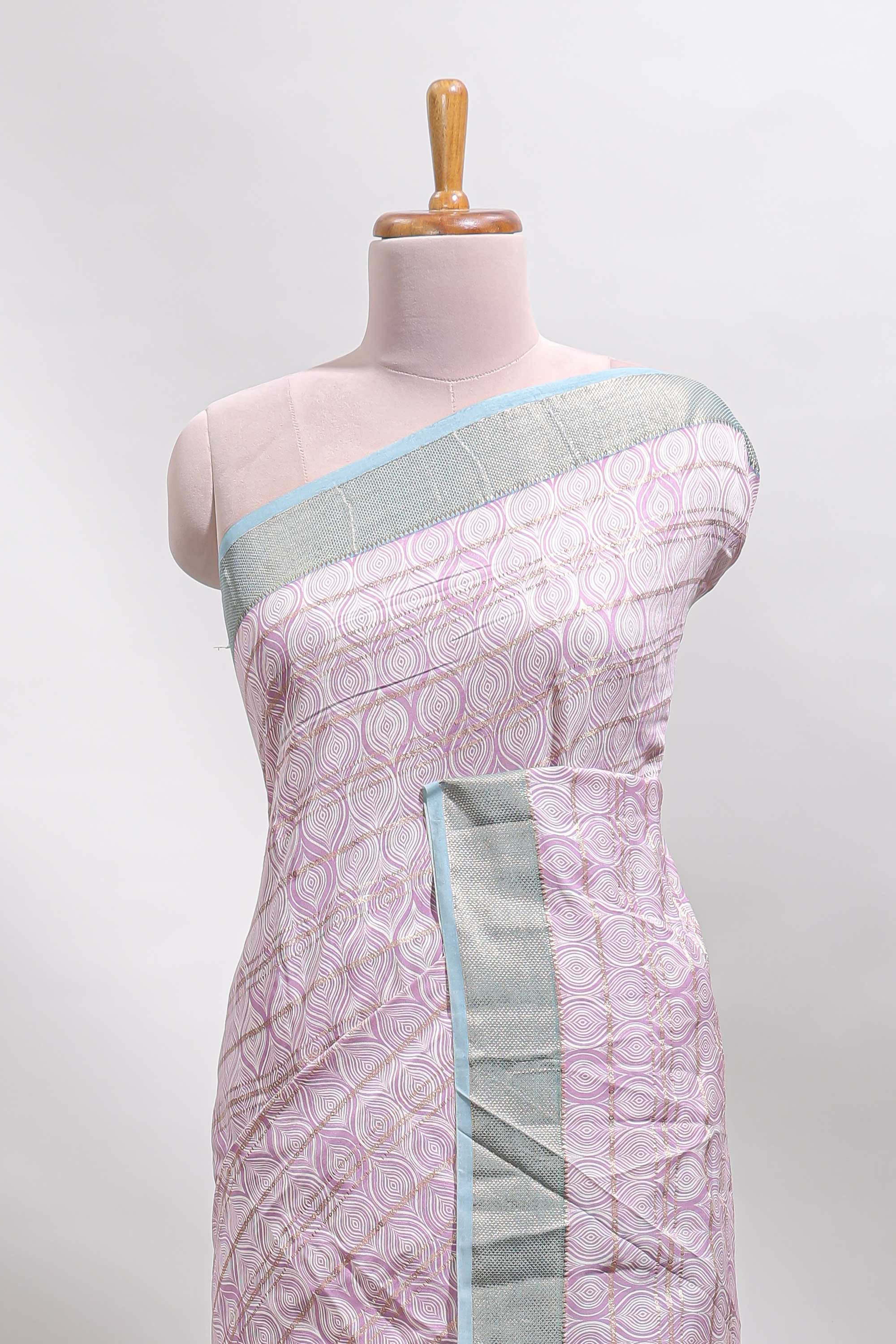 Baby pink geometric design tussar saree with contrast zari border and striped blouse