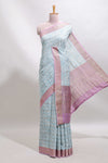 Blue geometric design tussar saree with contrast zari border and striped blouse