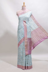 Blue geometric design tussar saree with contrast zari border and striped blouse