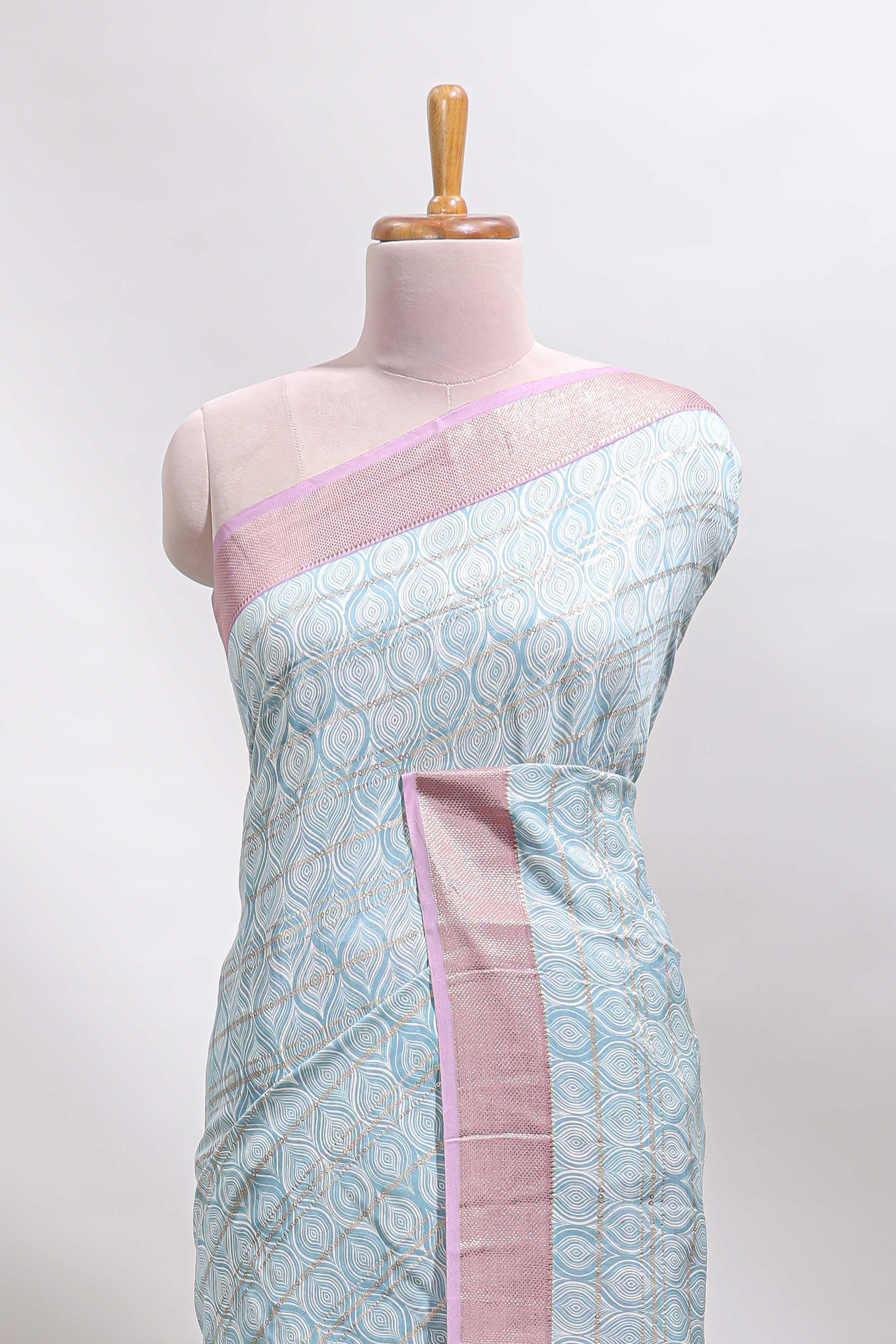Blue geometric design tussar saree with contrast zari border and striped blouse