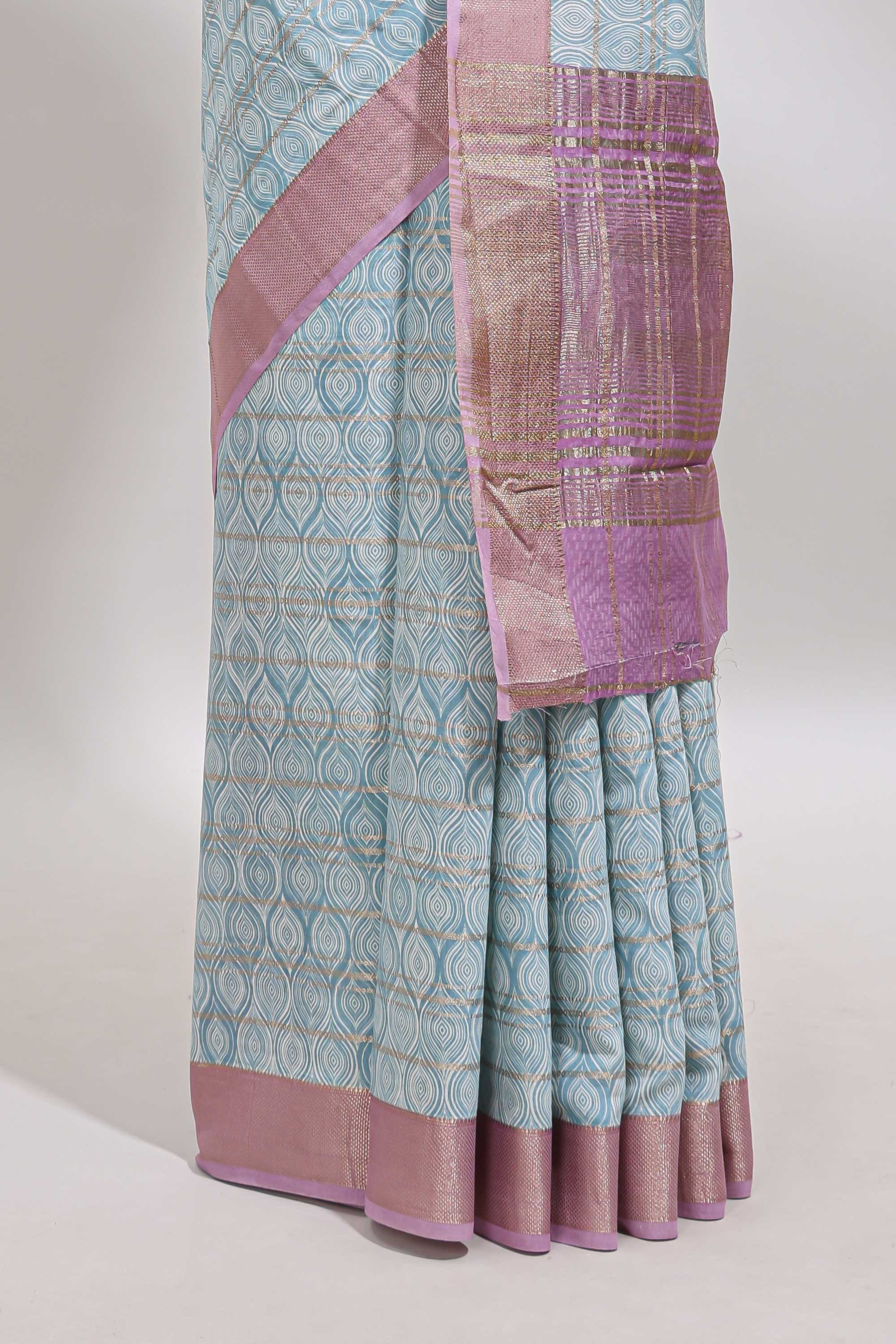 Blue geometric design tussar saree with contrast zari border and striped blouse