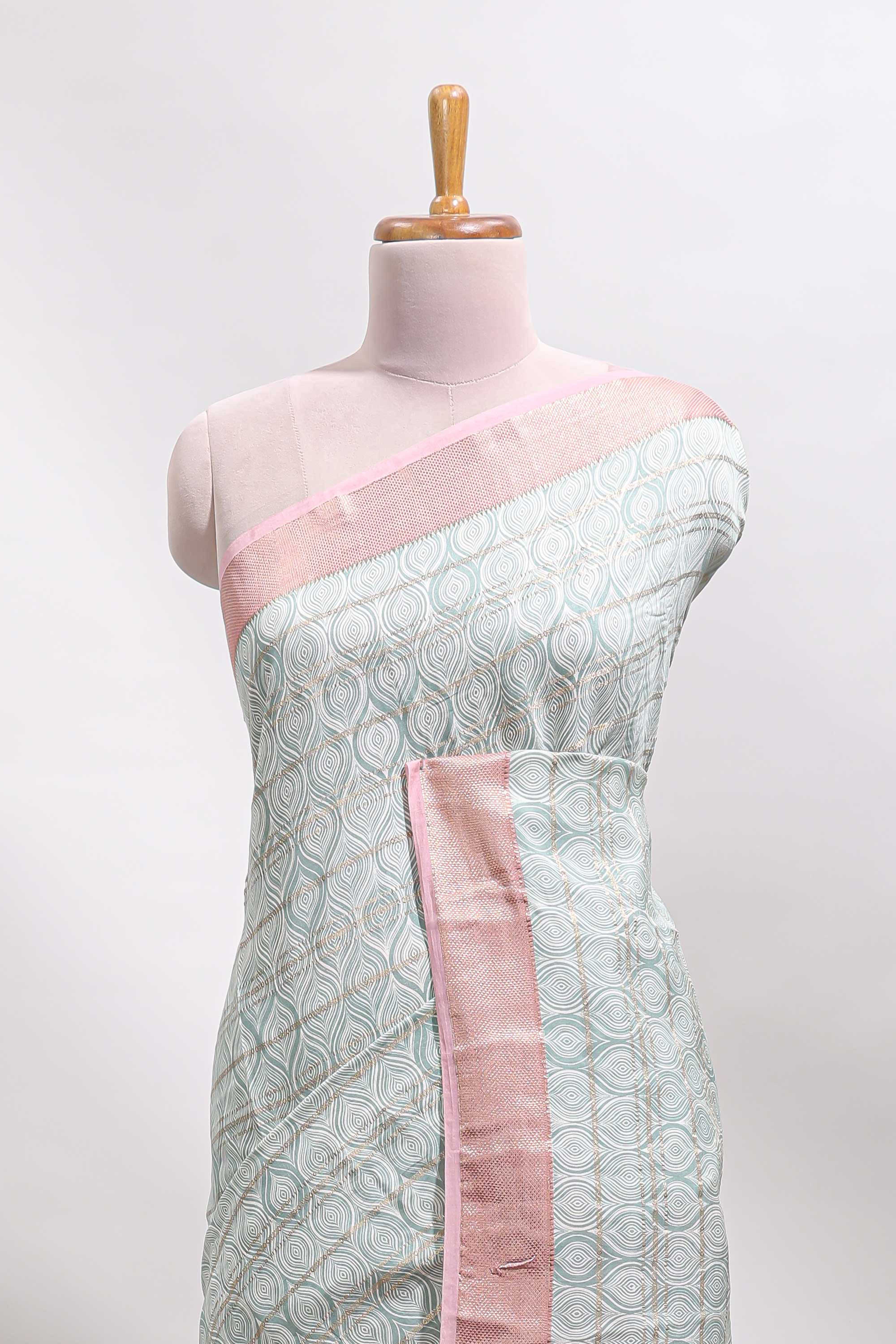 Green geometric design tussar saree with contrast zari border and striped blouse