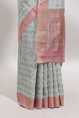 Green geometric design tussar saree with contrast zari border and striped blouse