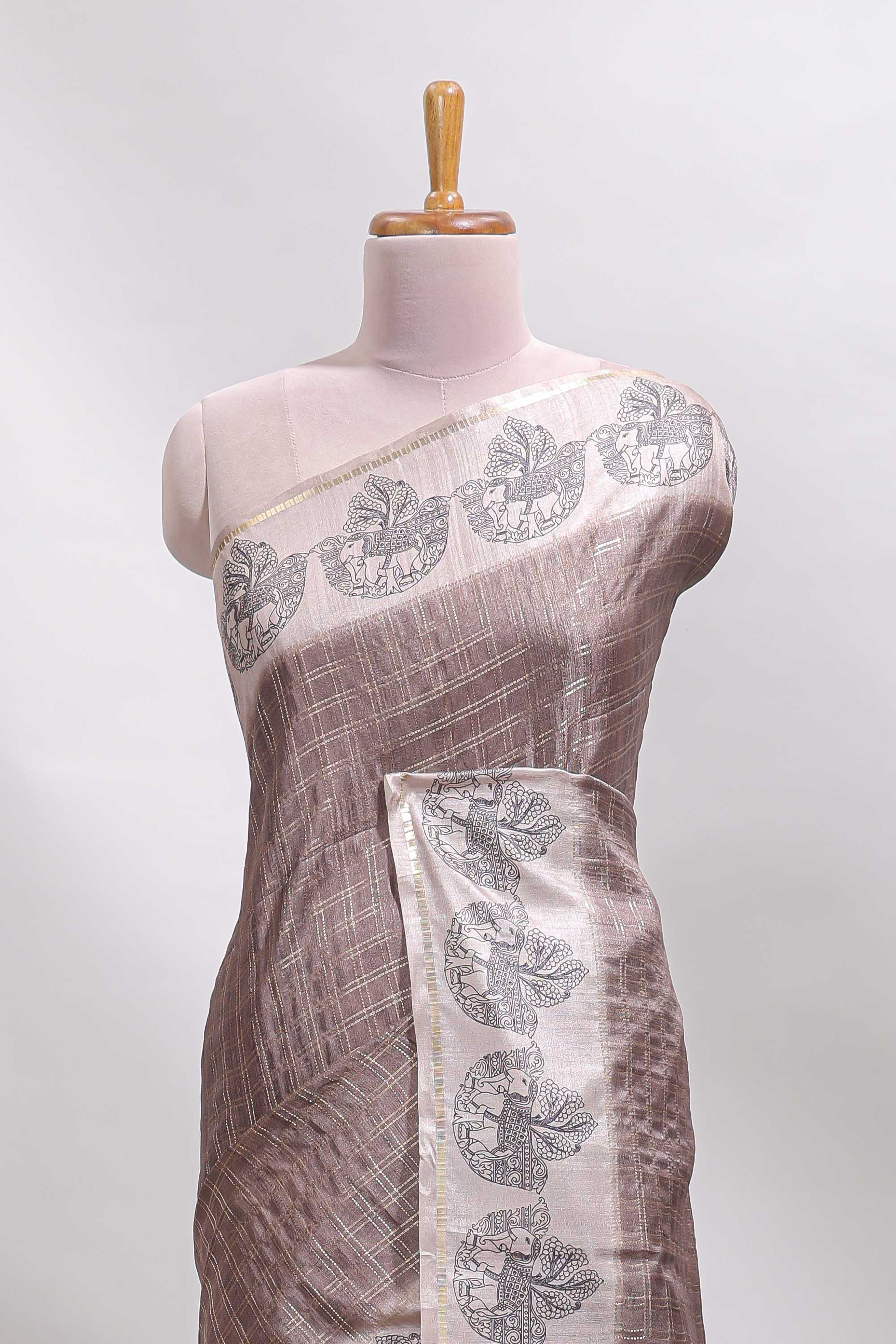 Brown checked tussar saree with contrast traditional elephant border and matching blouse