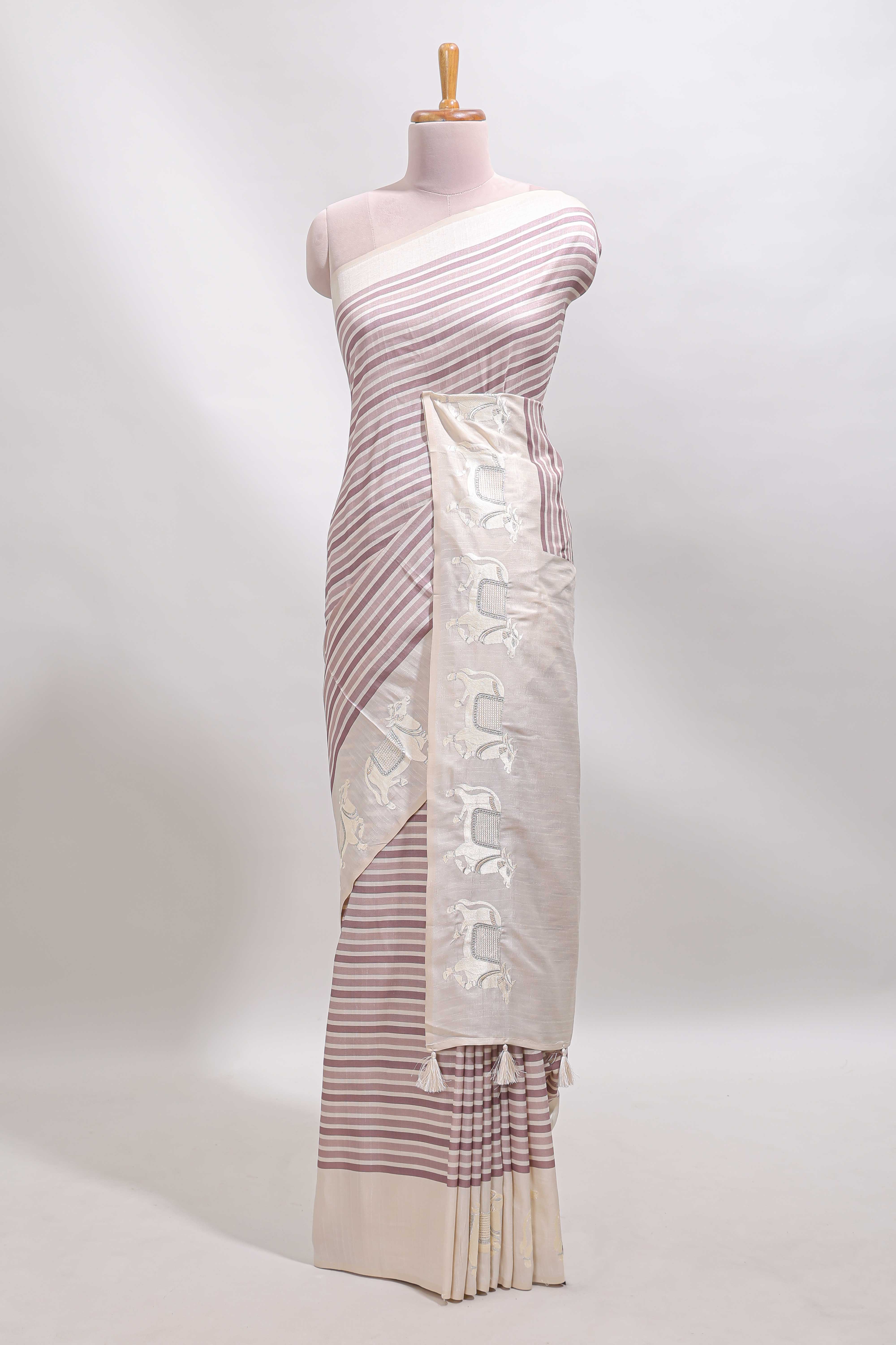 Cream striped tussar saree with contrast border and matching printed blouse