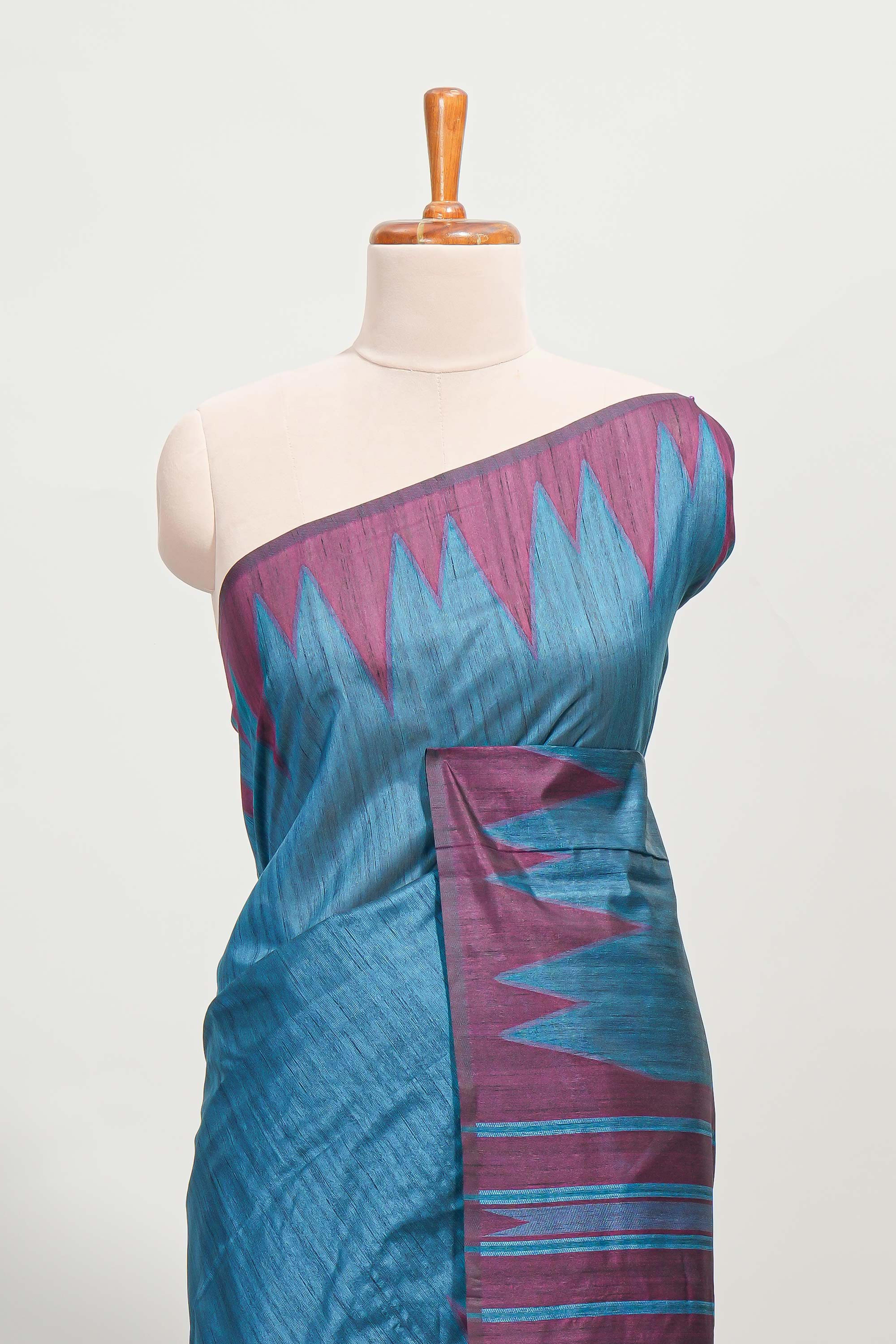 Blue plain semi tussar saree with contrast geometric border and motifs blouse