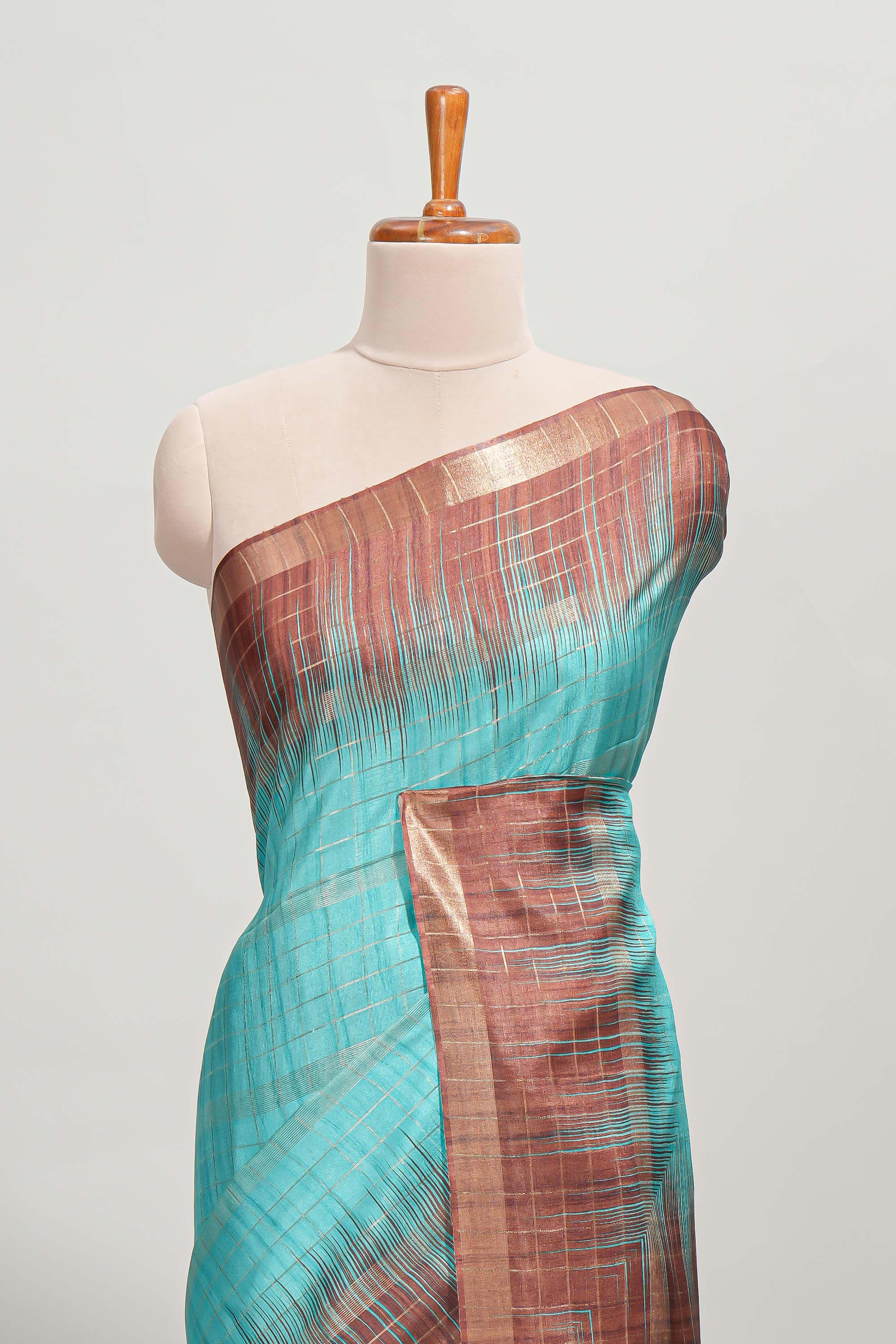 Turquoise green checked semi tussar saree with contrast border and striped blouse