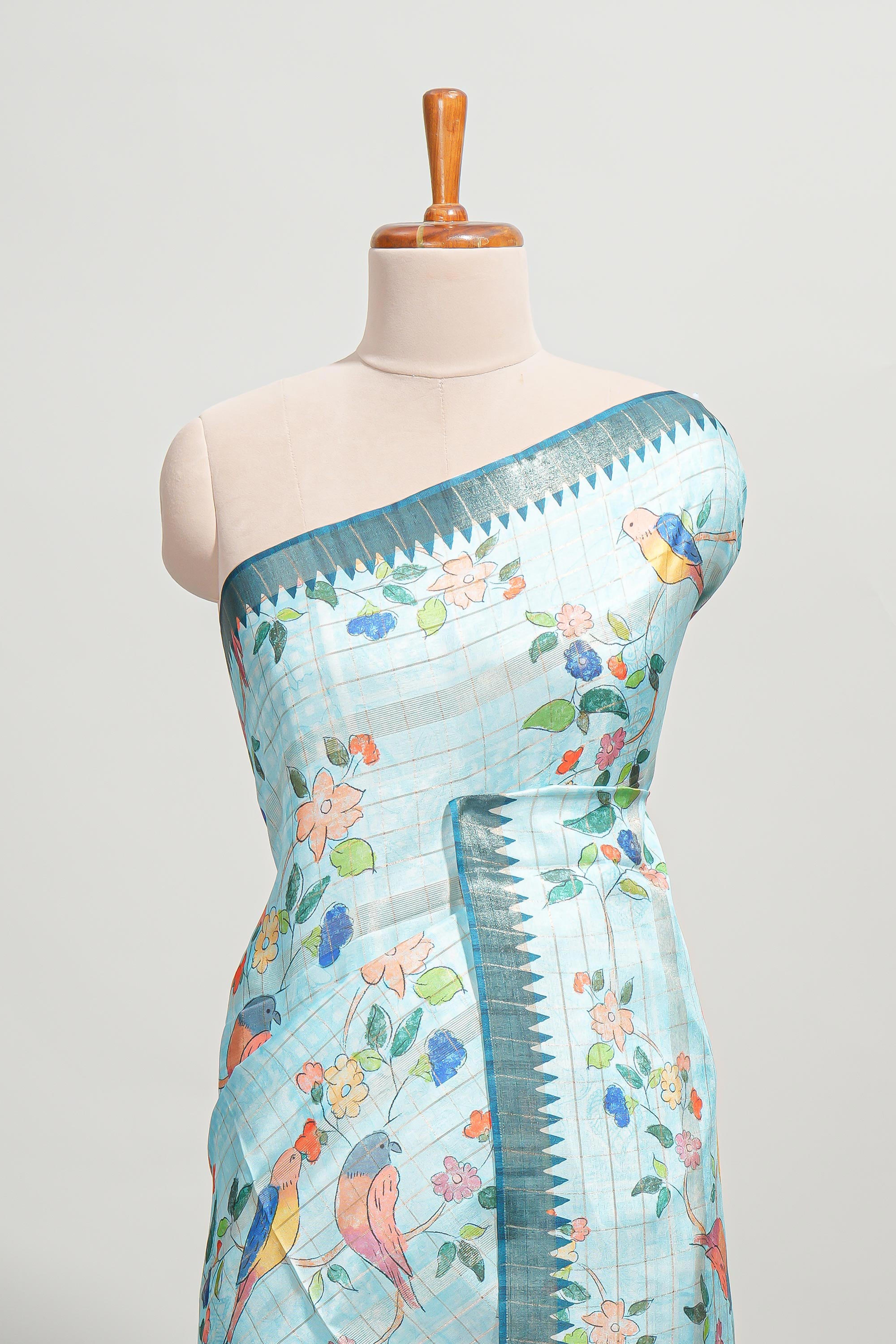 Powder blue checked birds & floral design semi tussar saree with contrast border and checked blouse