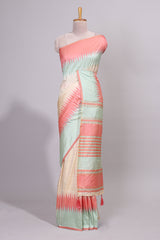 Off white ikkat design semi tussar saree with contrast dual shade border and matching striped blouse