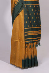 Mustard ikkat motifs design semi tussar saree with contrast green border and striped blouse