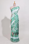 Green Tussar saree with a floral body featuring bird motifs a printed pallu with tassels and a matchingfloral blouse piece