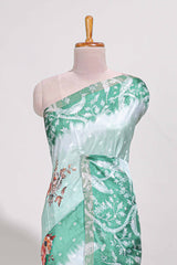 Green Tussar saree with a floral body featuring bird motifs a printed pallu with tassels and a matchingfloral blouse piece