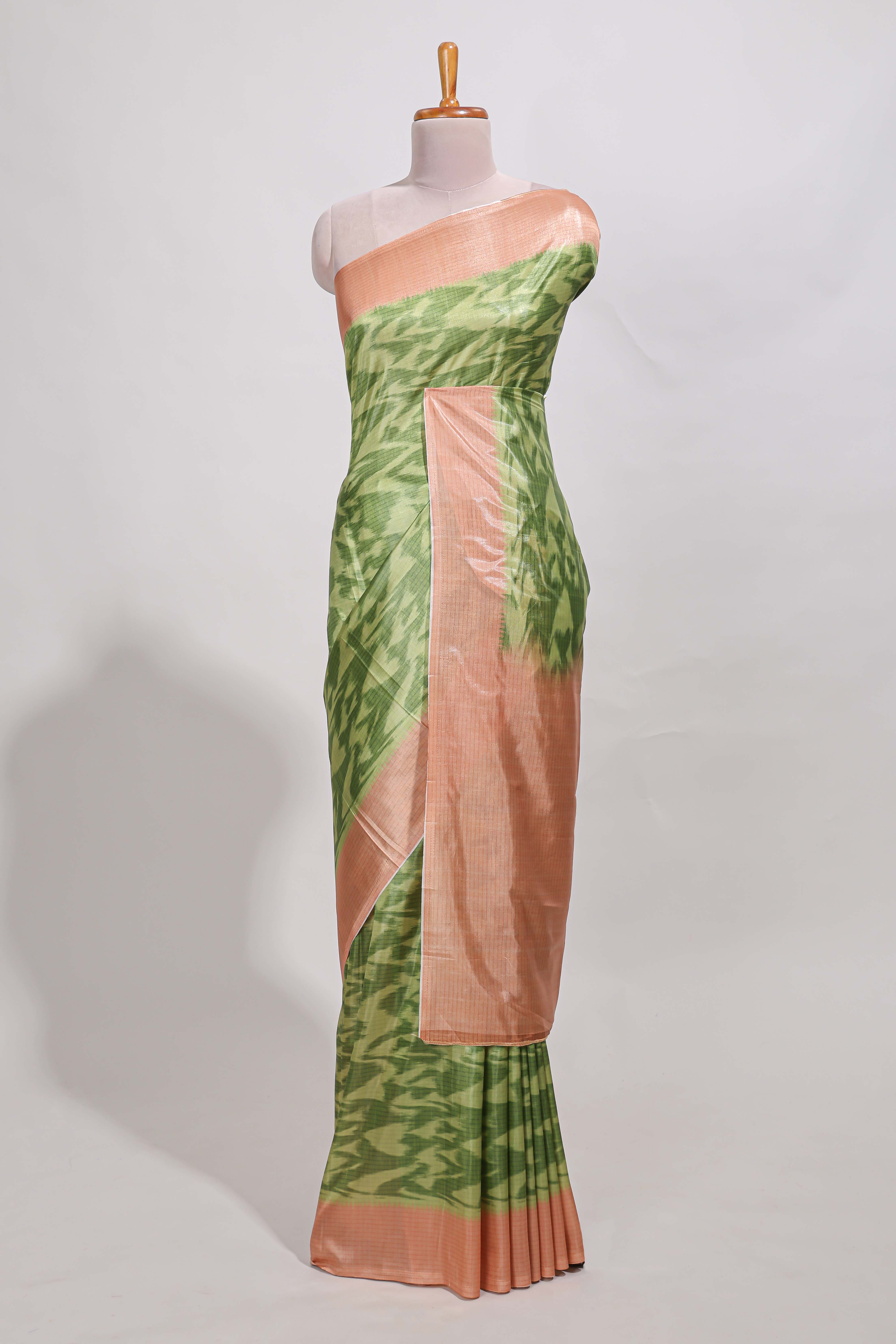 green colour ikkatdesignsemi tussar saree with contrast border andblouse