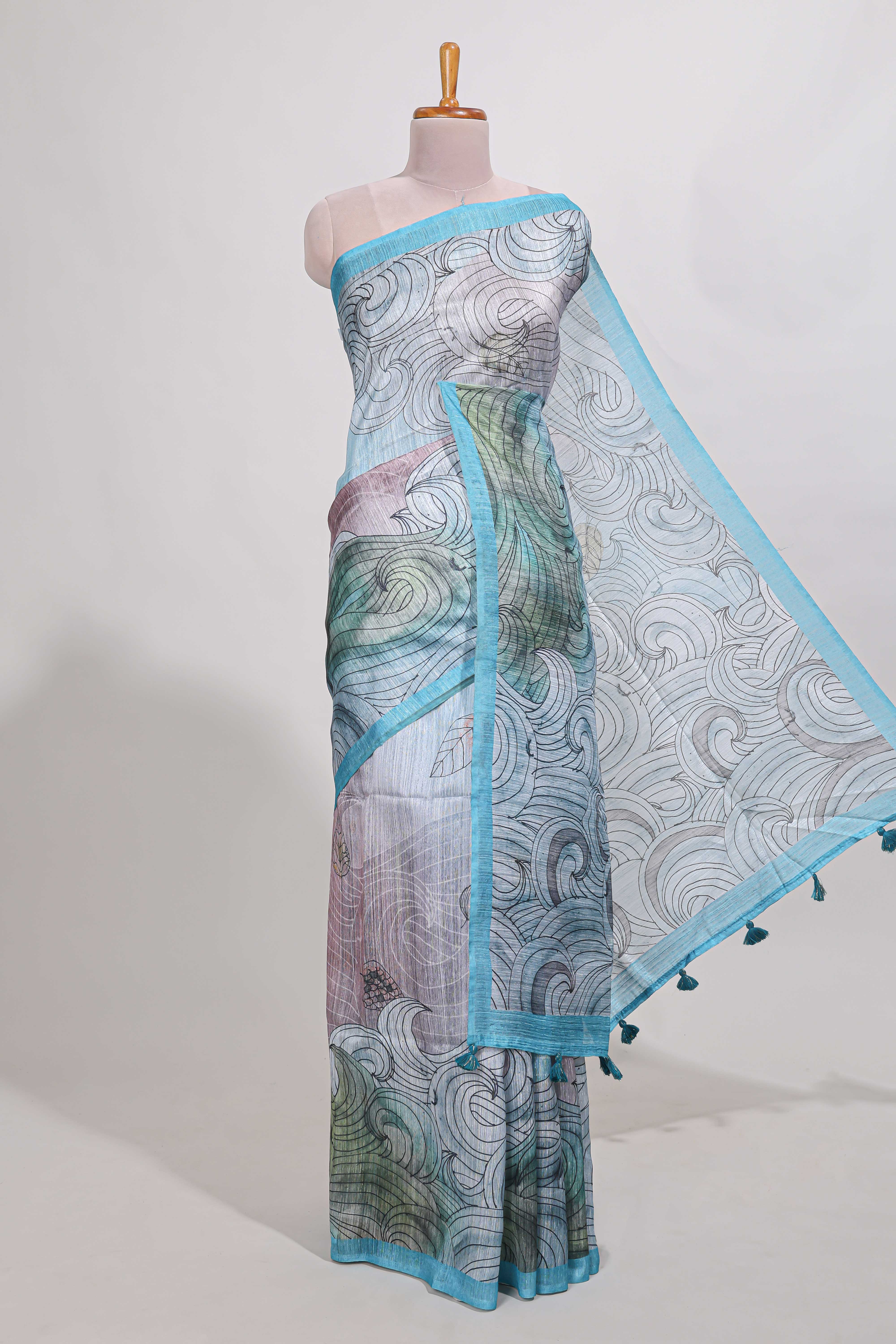 Blue colourprintedsemi tussar saree with pippingborder and leaf printed matching blouse