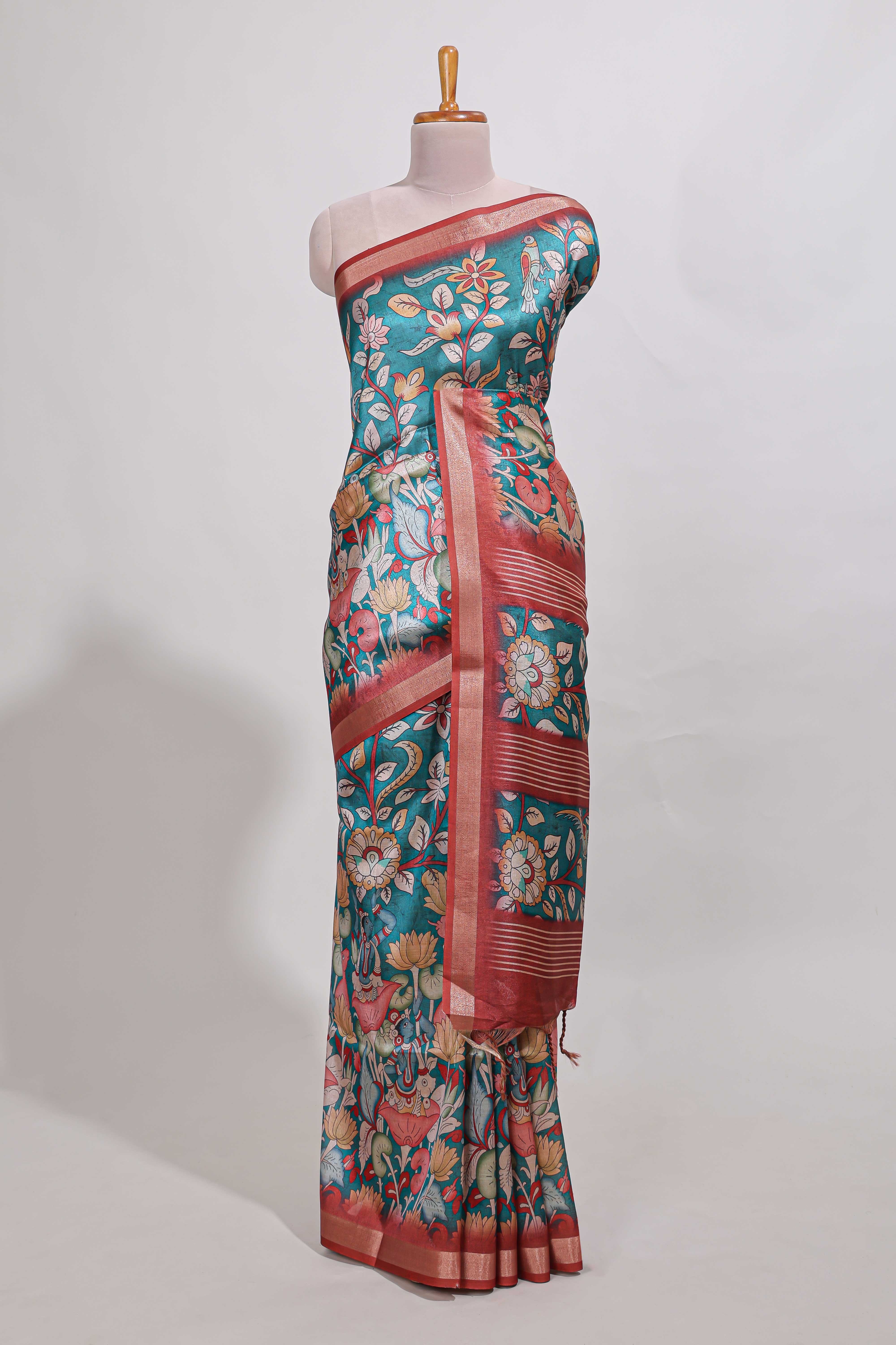 Turkish blue kalamkari style tussar saree with small zari border and print pallu with floral print blouse