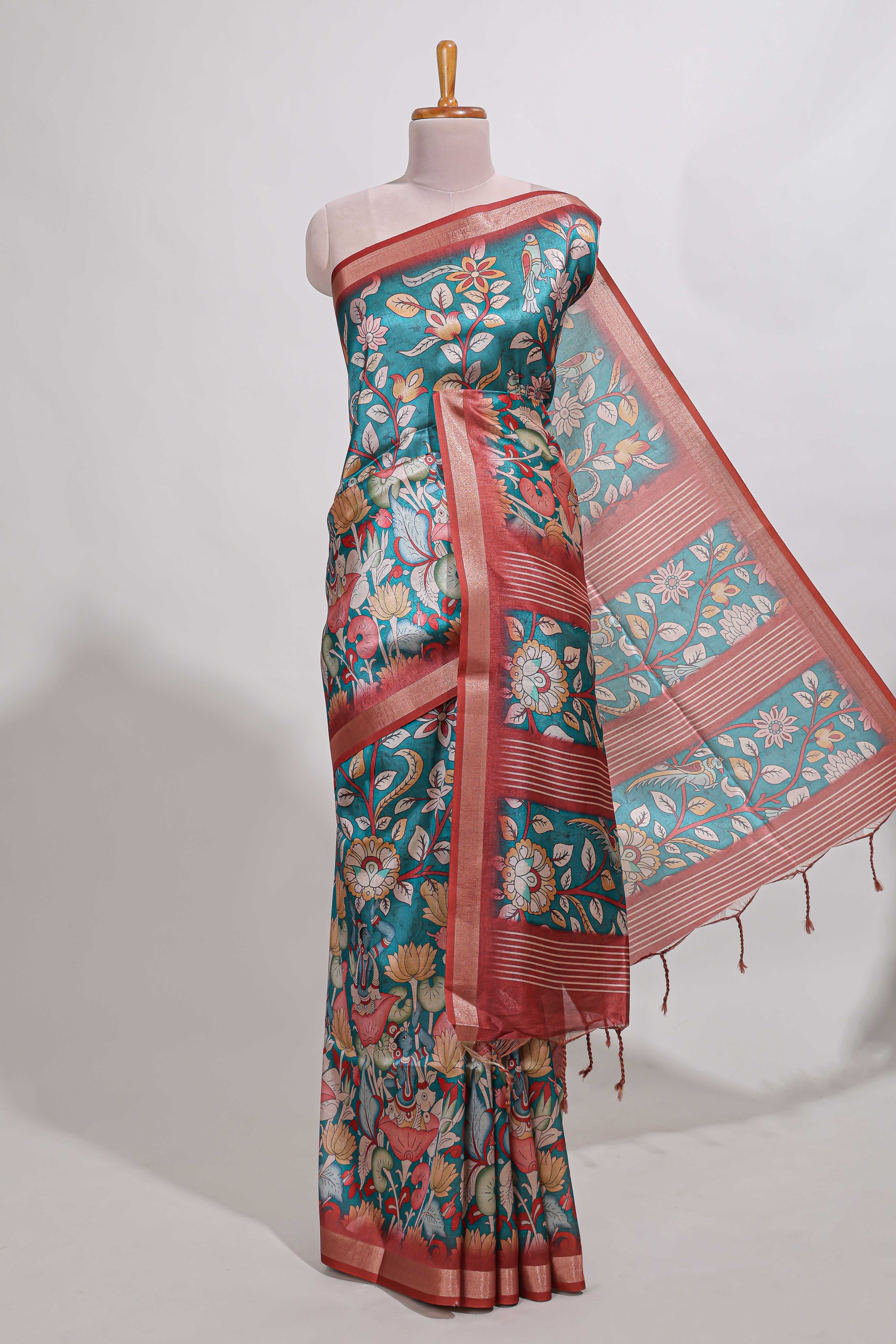 Green kalamkari style tussar saree with small zari border and print pallu with floral print blouse