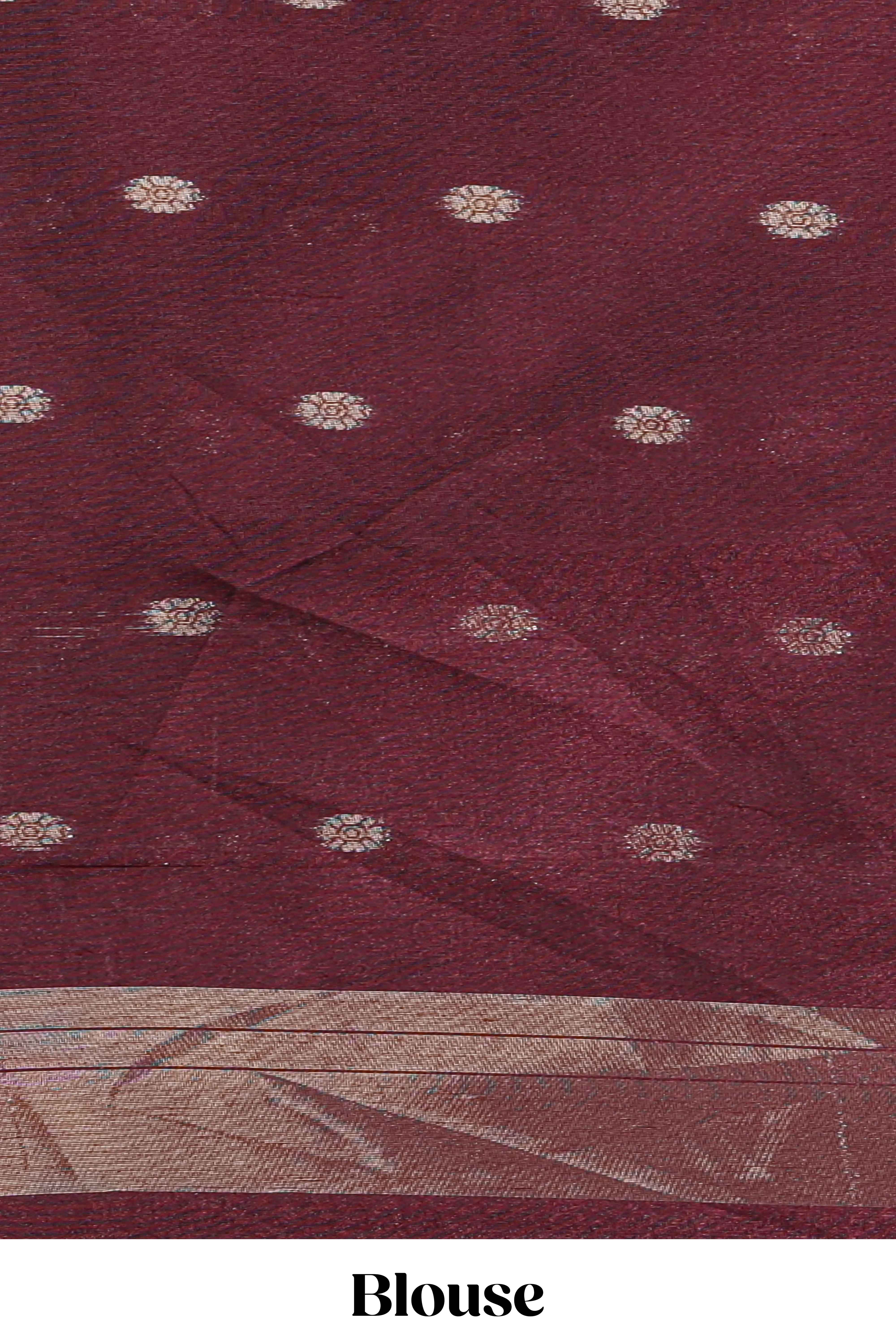 Maroon shimmering zari tussar saree with zari detailing temple pattern borders , and a rich zari pallu
