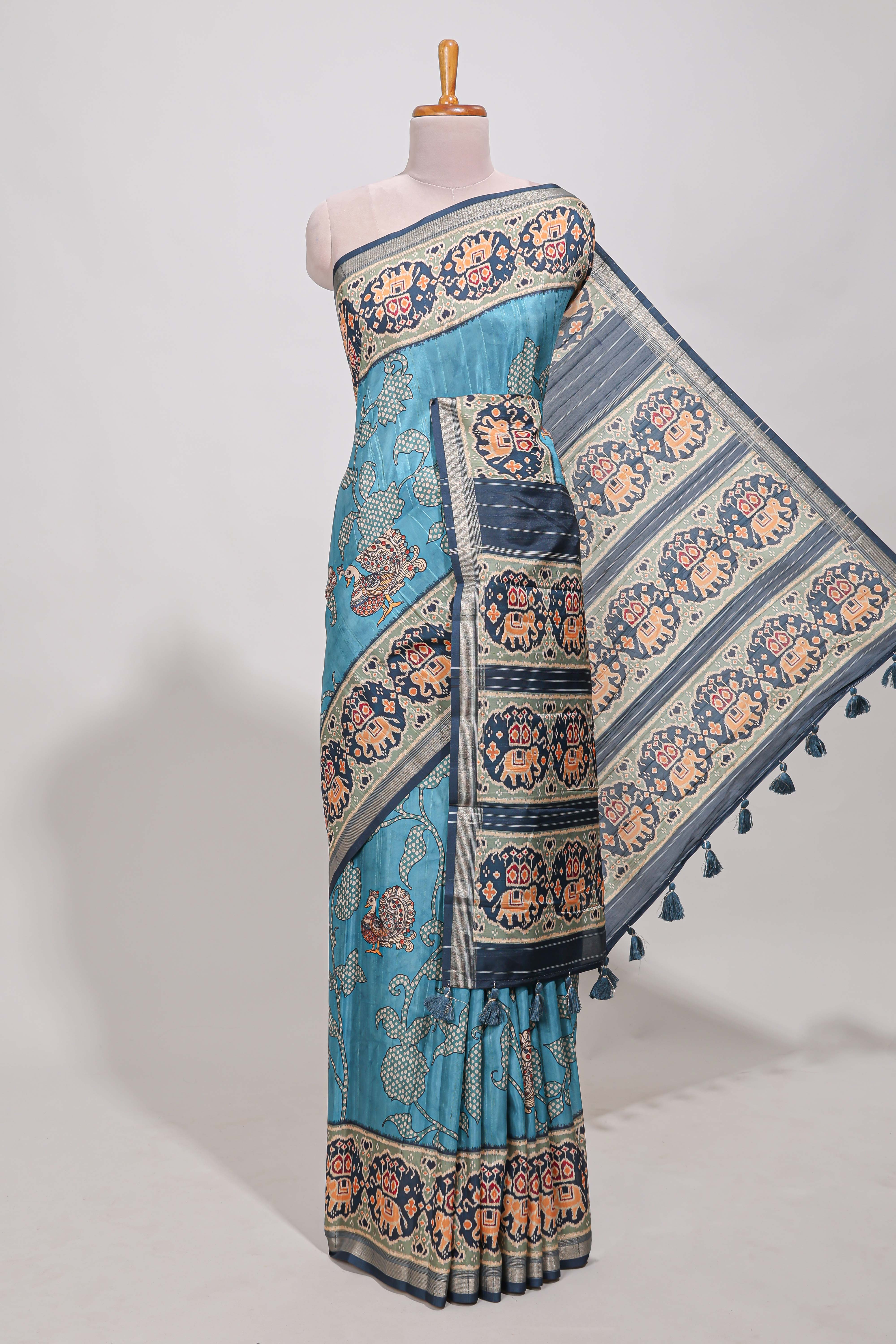 Blue patolatussar saree pichwai art and peacock motifs elephant designs with rich matching pallu along with tussels