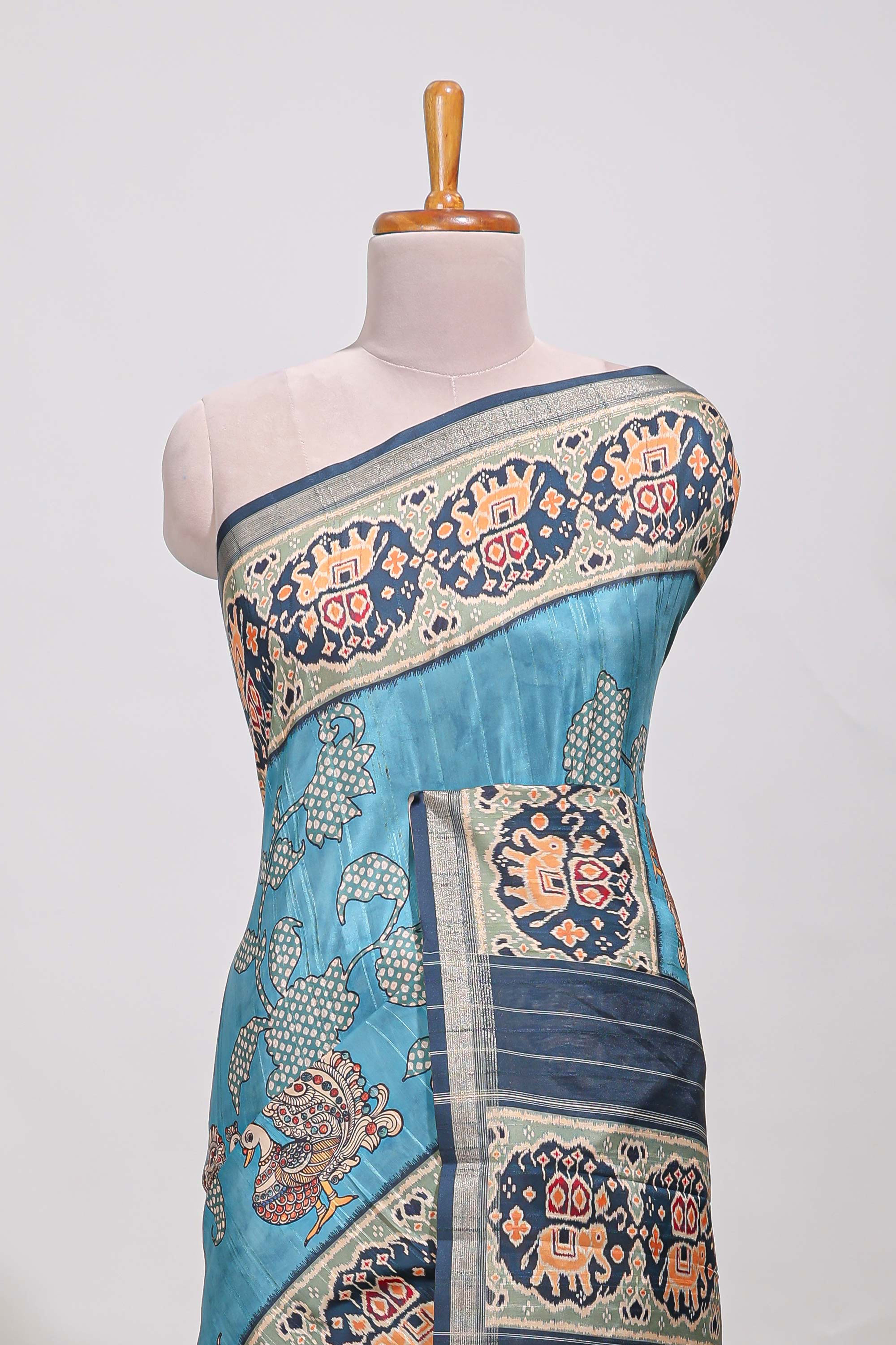 Blue patolatussar saree pichwai art and peacock motifs elephant designs with rich matching pallu along with tussels
