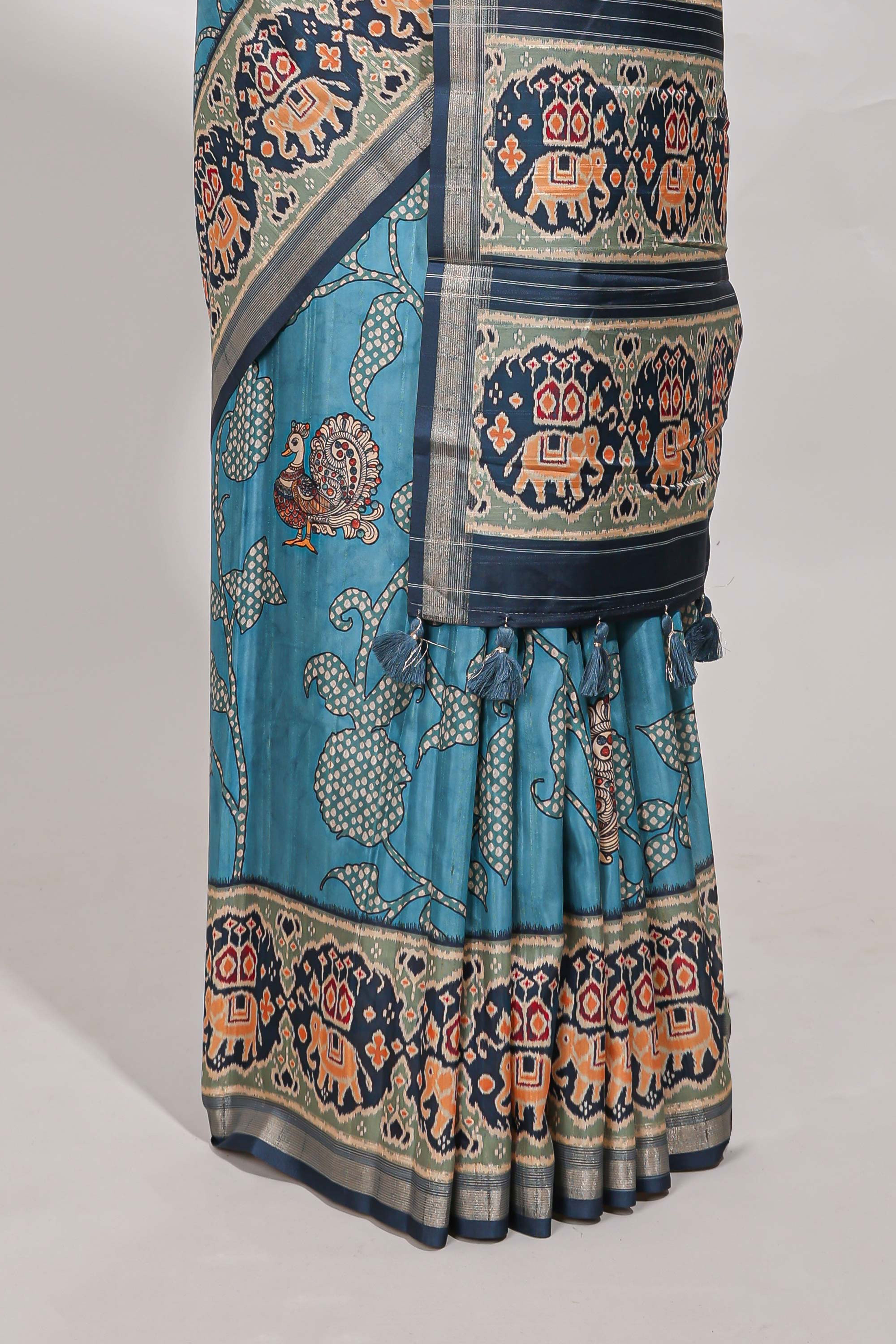 Blue patolatussar saree pichwai art and peacock motifs elephant designs with rich matching pallu along with tussels