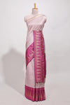 Peach semi tussar sareeall-over fine checked zari with border geometric zig-zag metallic weaving and contrast blouse
