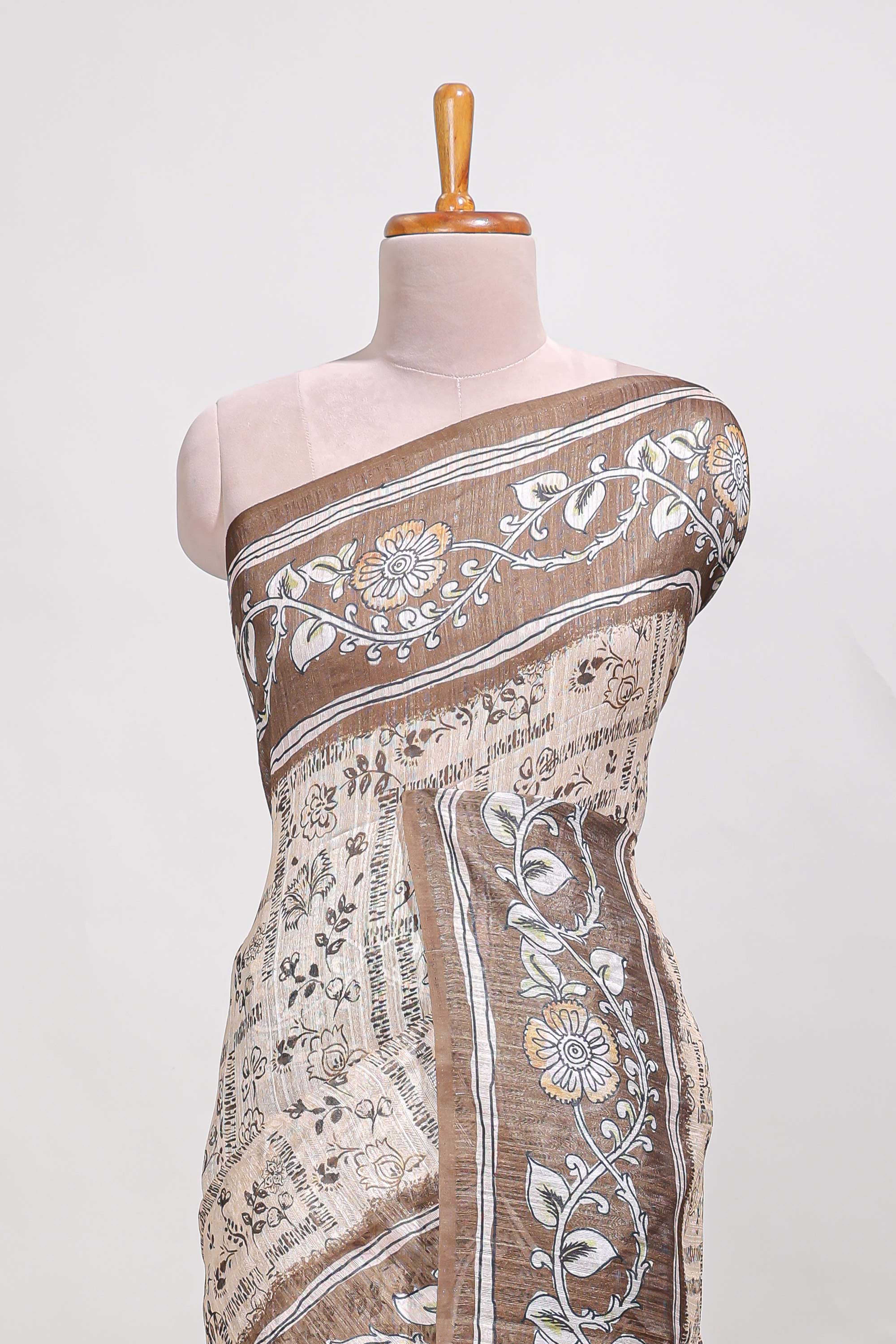 Brown colour floral printedsemi tussar saree with creeperborder and matching printed blouse