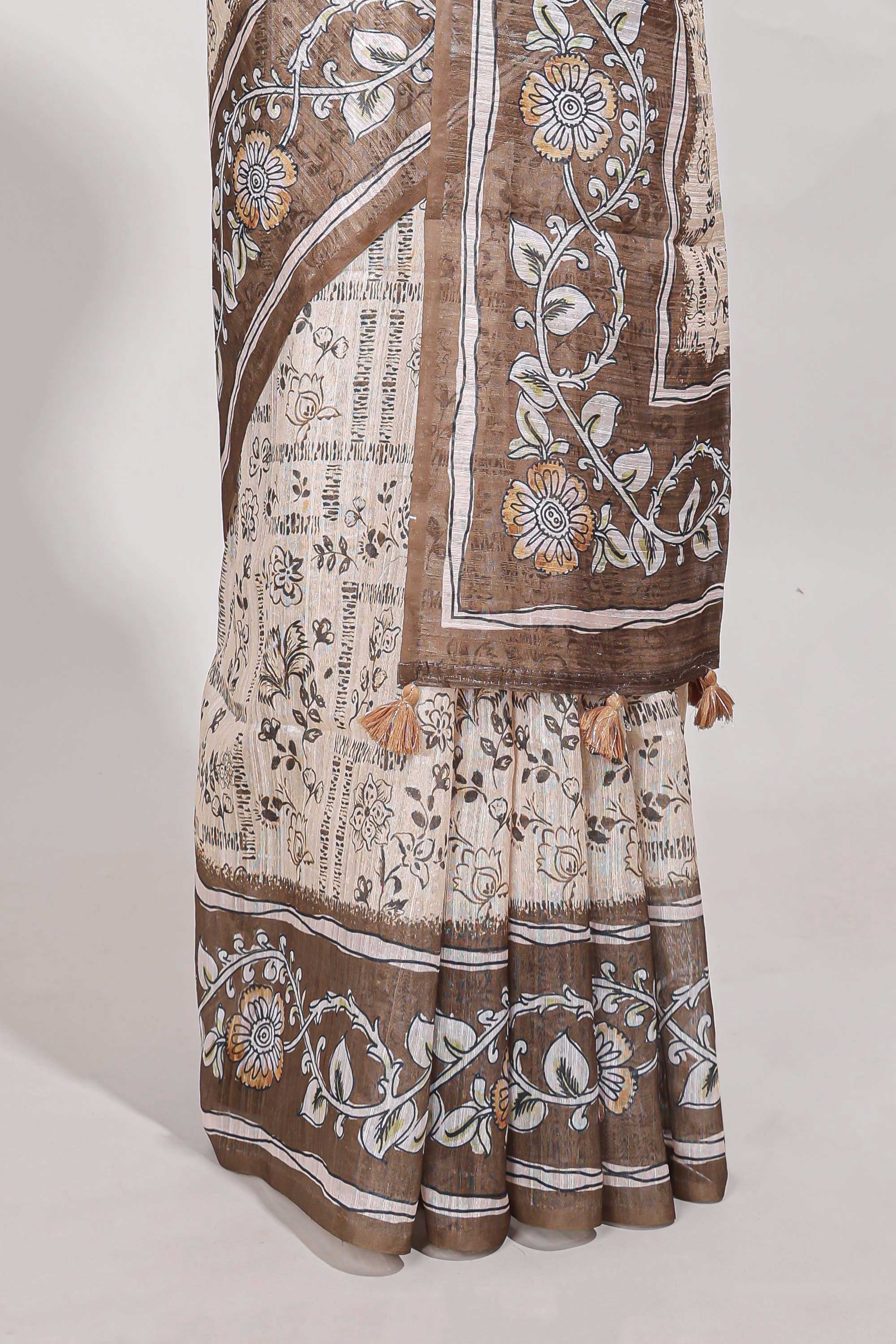 Brown colour floral printedsemi tussar saree with creeperborder and matching printed blouse