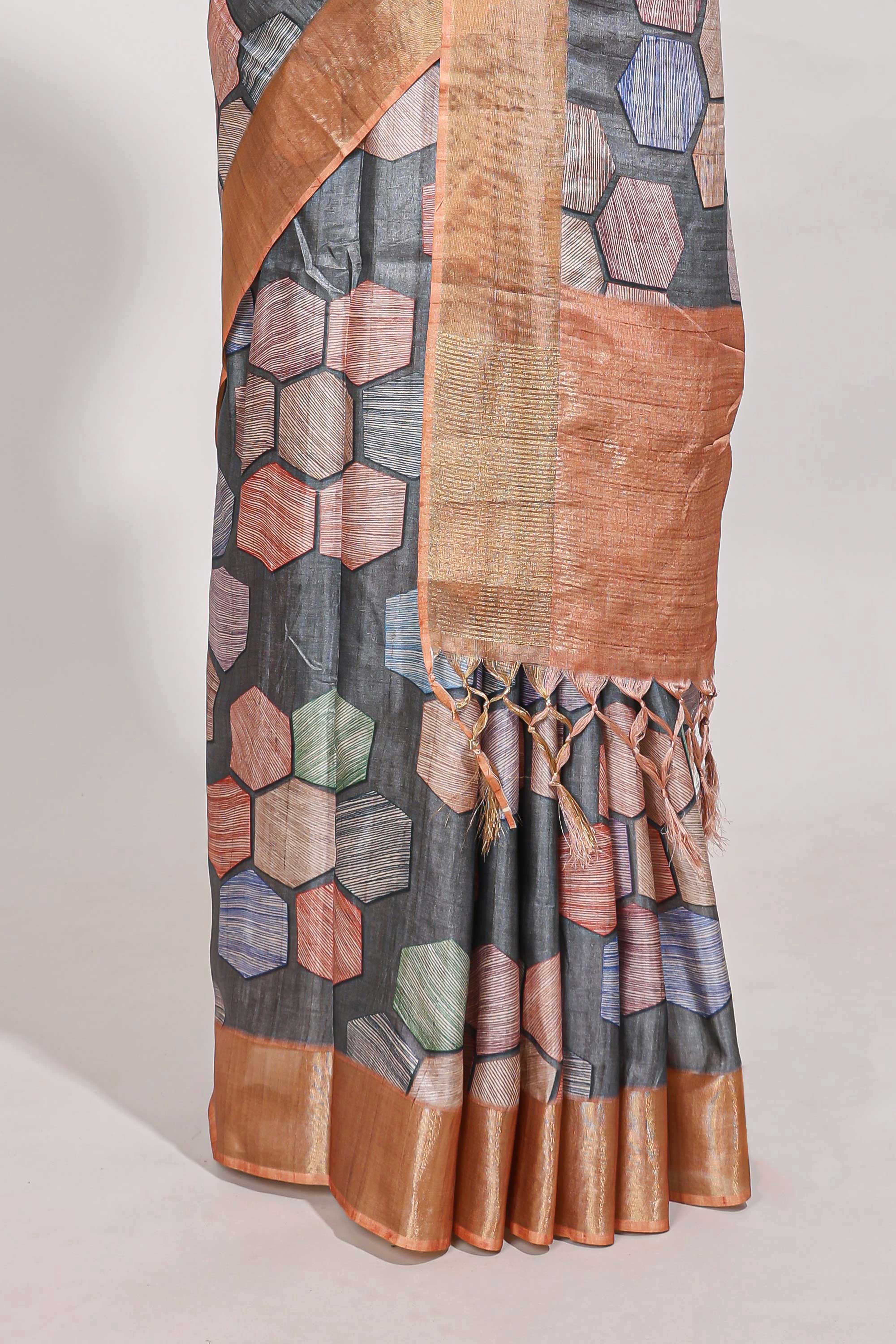 Grey geometrical tussar silk saree multi coloured honeycomb geomatricpatterns rich matching pallu along with tassles
