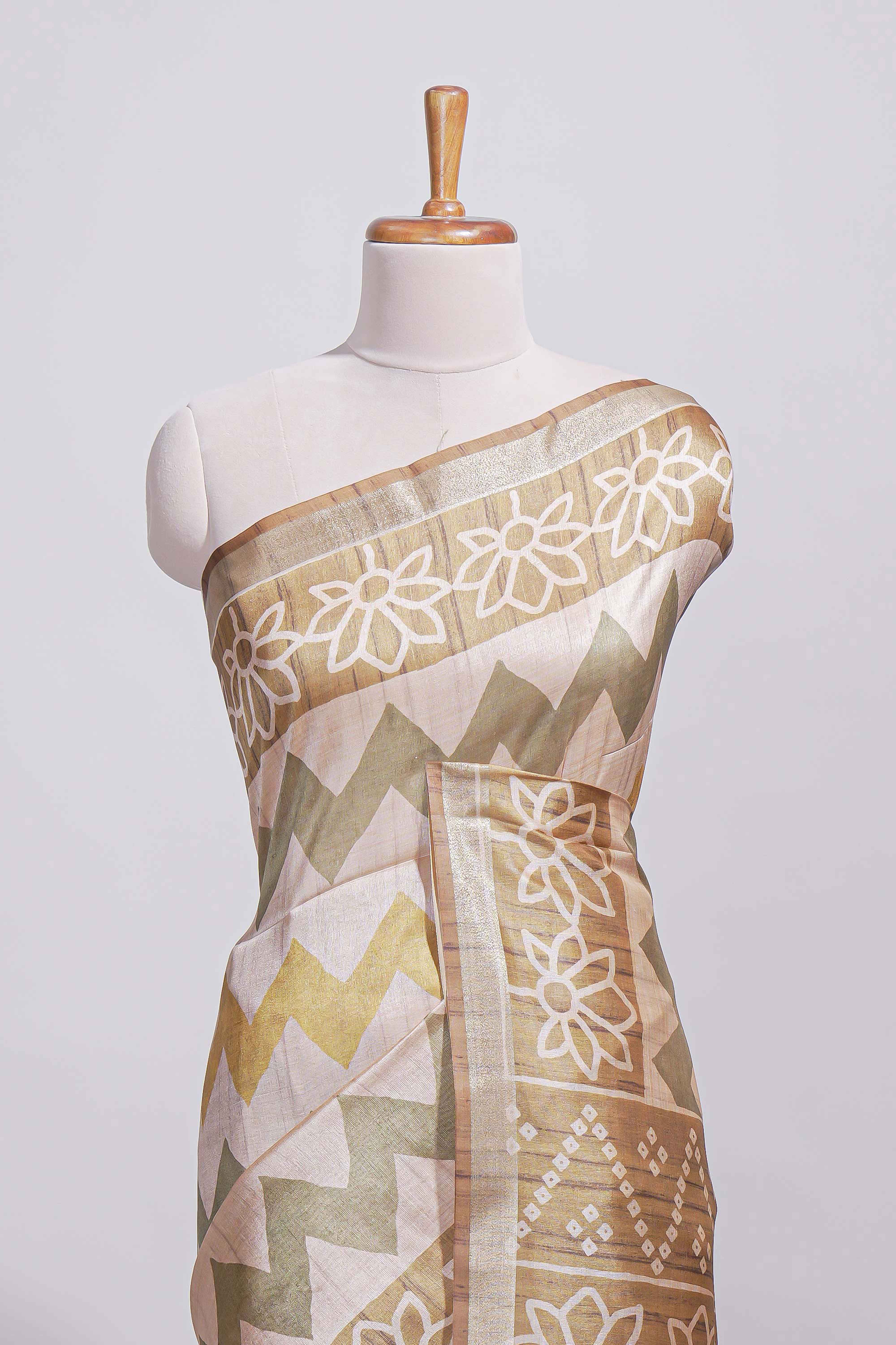Beige and ivory tussar saree body chevron prints floral motifs and printed pallu along with matching blouse