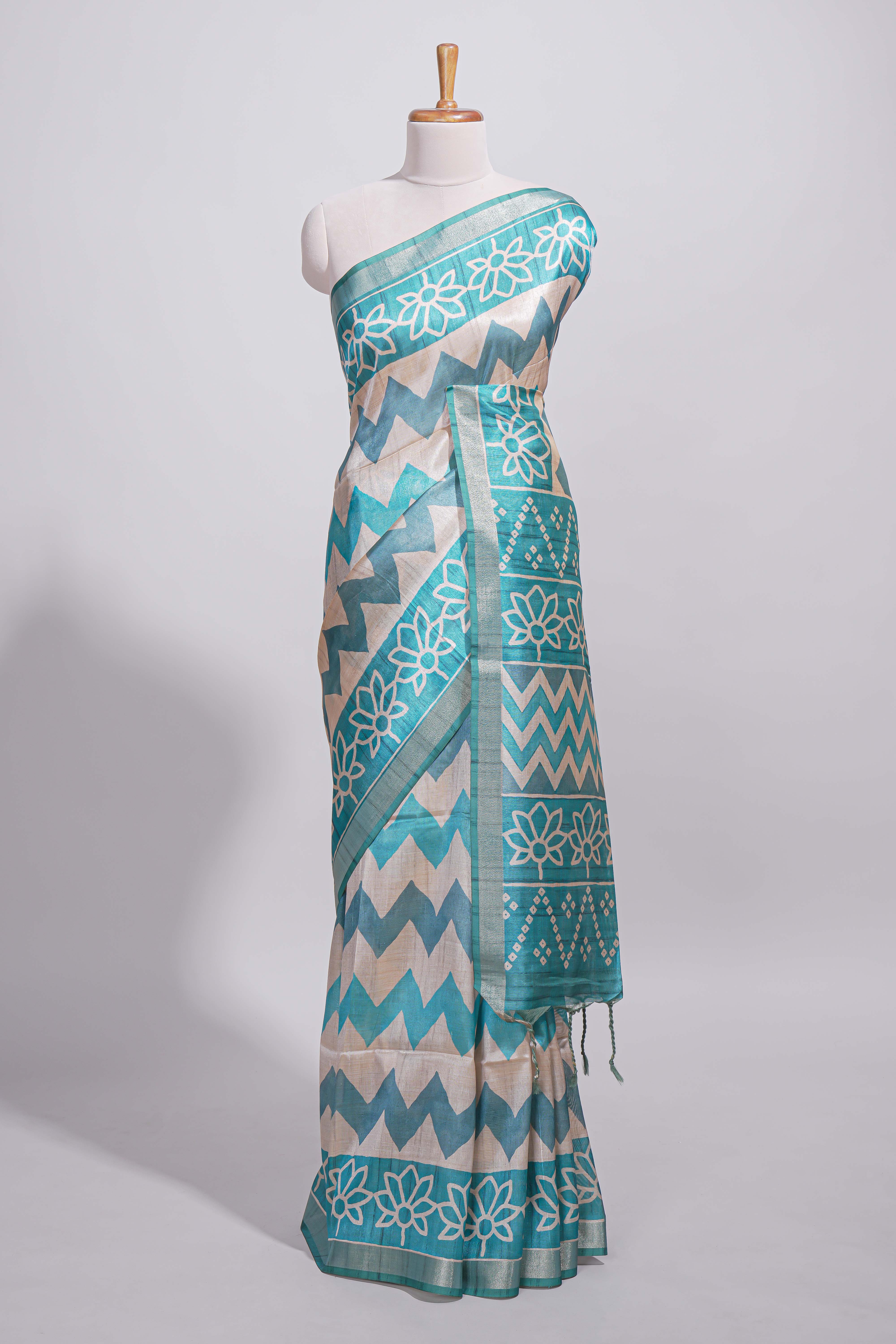 Teal blue tussar saree body chevron prints floral motifs and printed pallu along with matching blouse