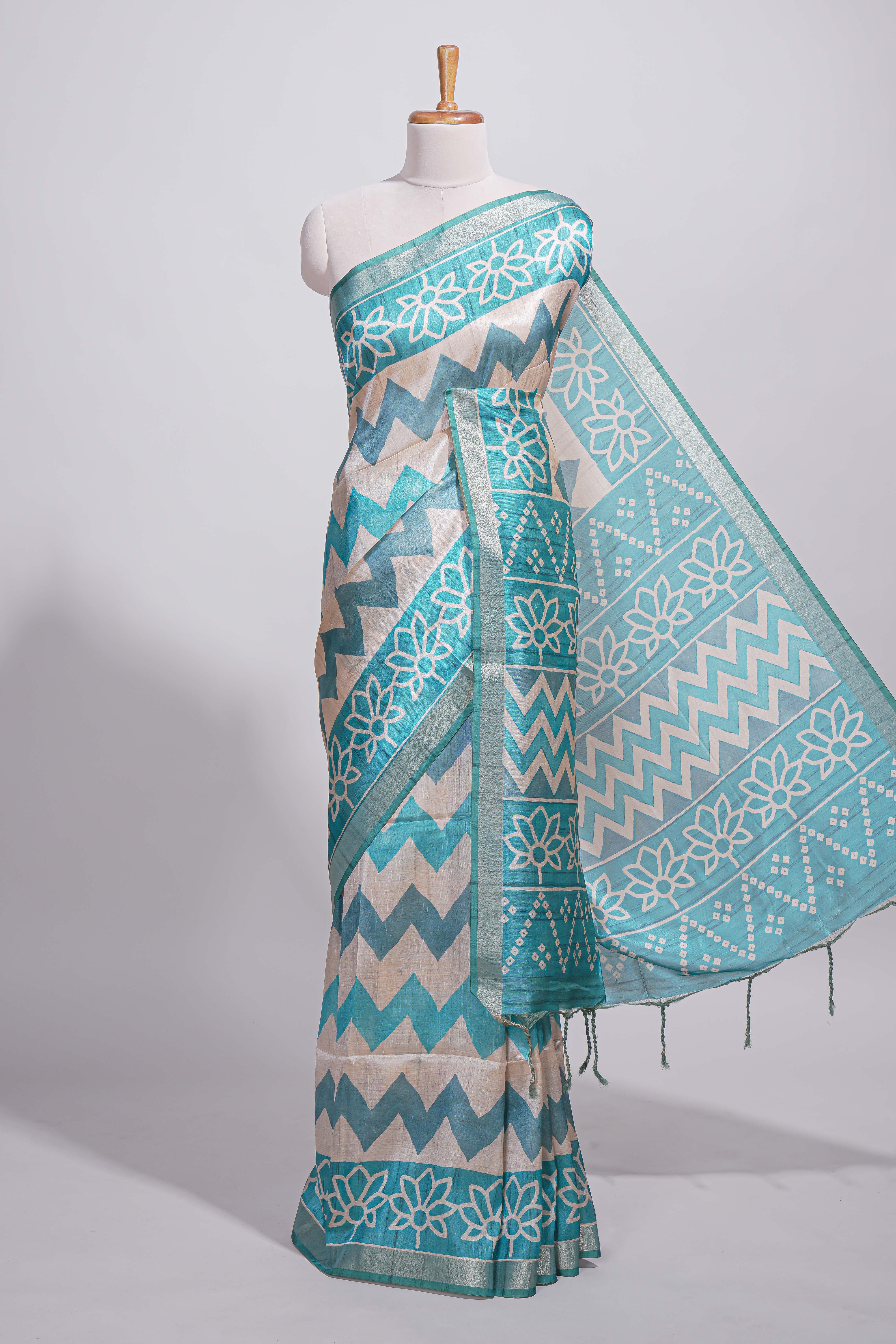 Teal blue tussar saree body chevron prints floral motifs and printed pallu along with matching blouse