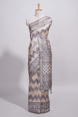 Grey and ivory color tussar saree body chevron prints floral motifs and printed pallu along with matching blouse