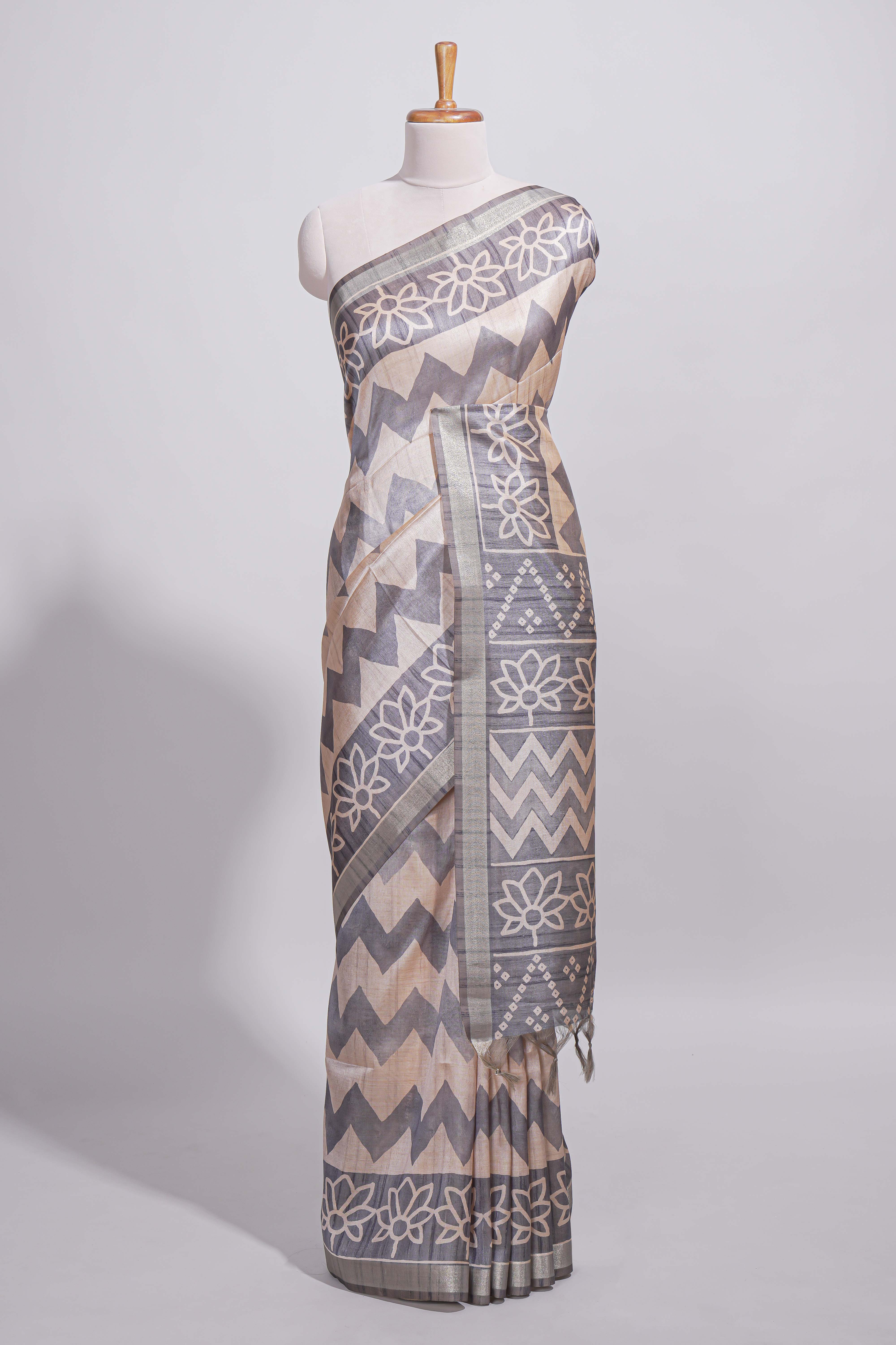 Grey and ivory color tussar saree body chevron prints floral motifs and printed pallu along with matching blouse