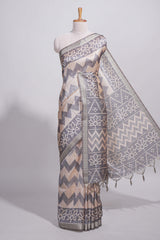 Grey and ivory color tussar saree body chevron prints floral motifs and printed pallu along with matching blouse