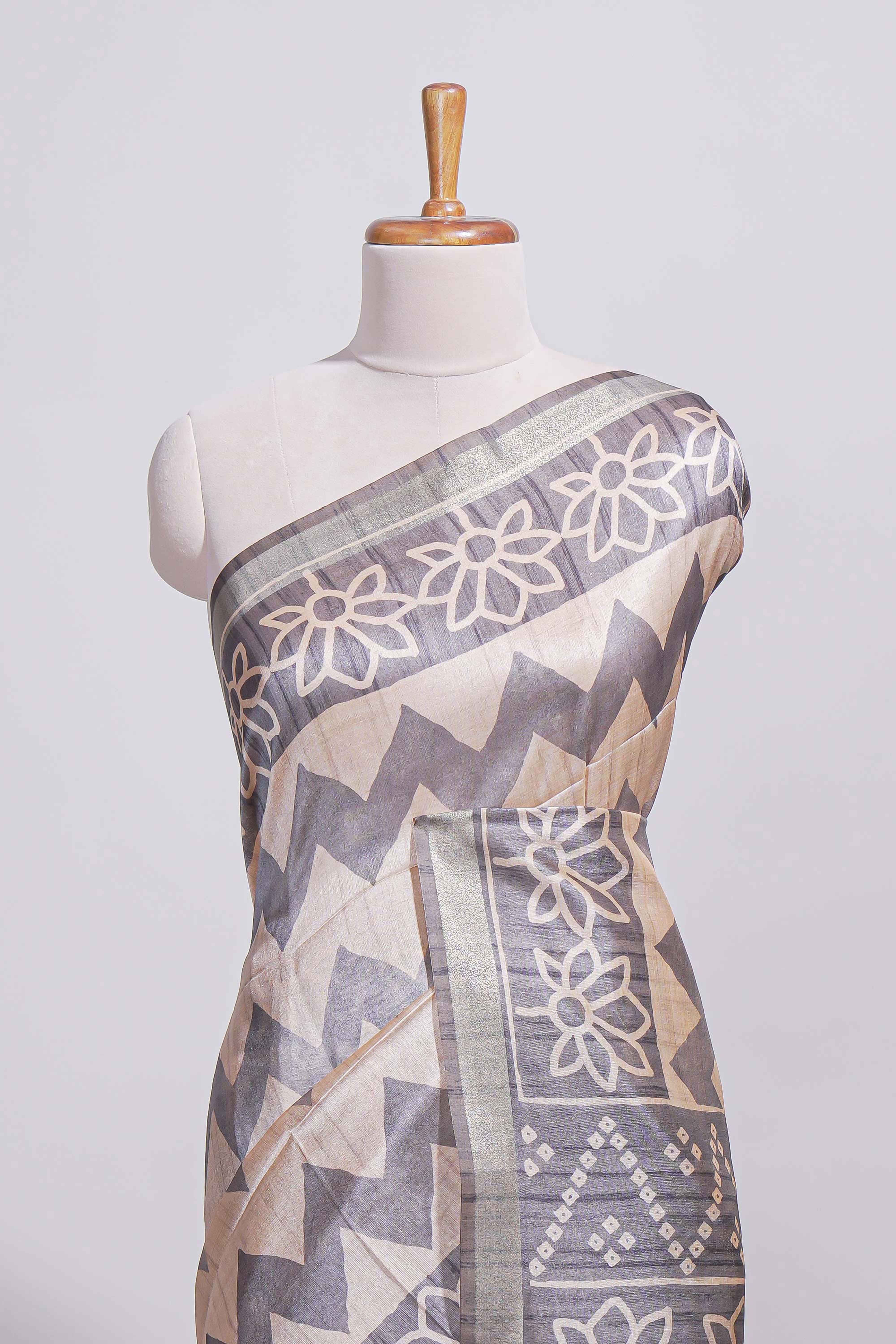 Grey and ivory color tussar saree body chevron prints floral motifs and printed pallu along with matching blouse