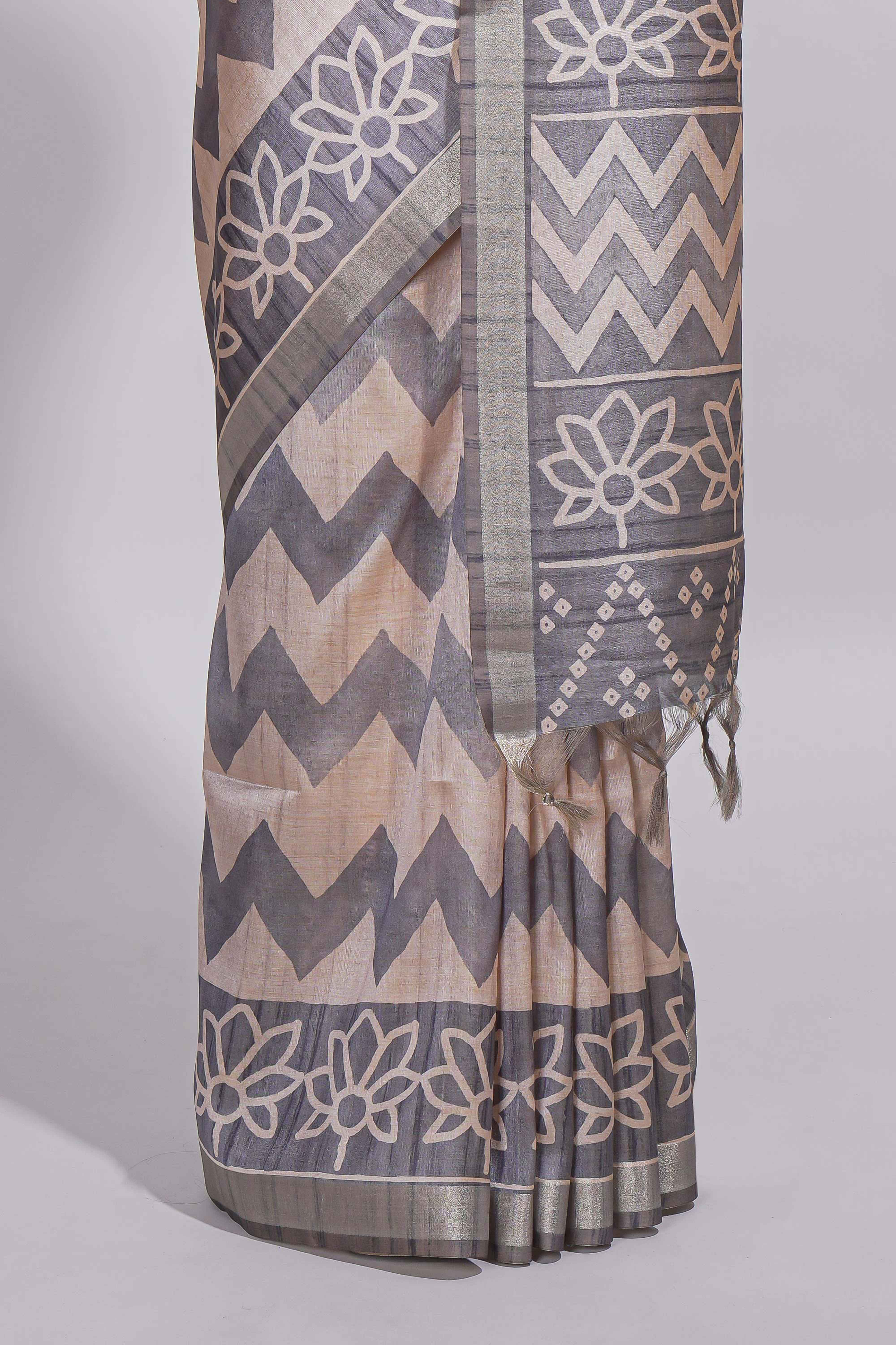 Grey and ivory color tussar saree body chevron prints floral motifs and printed pallu along with matching blouse