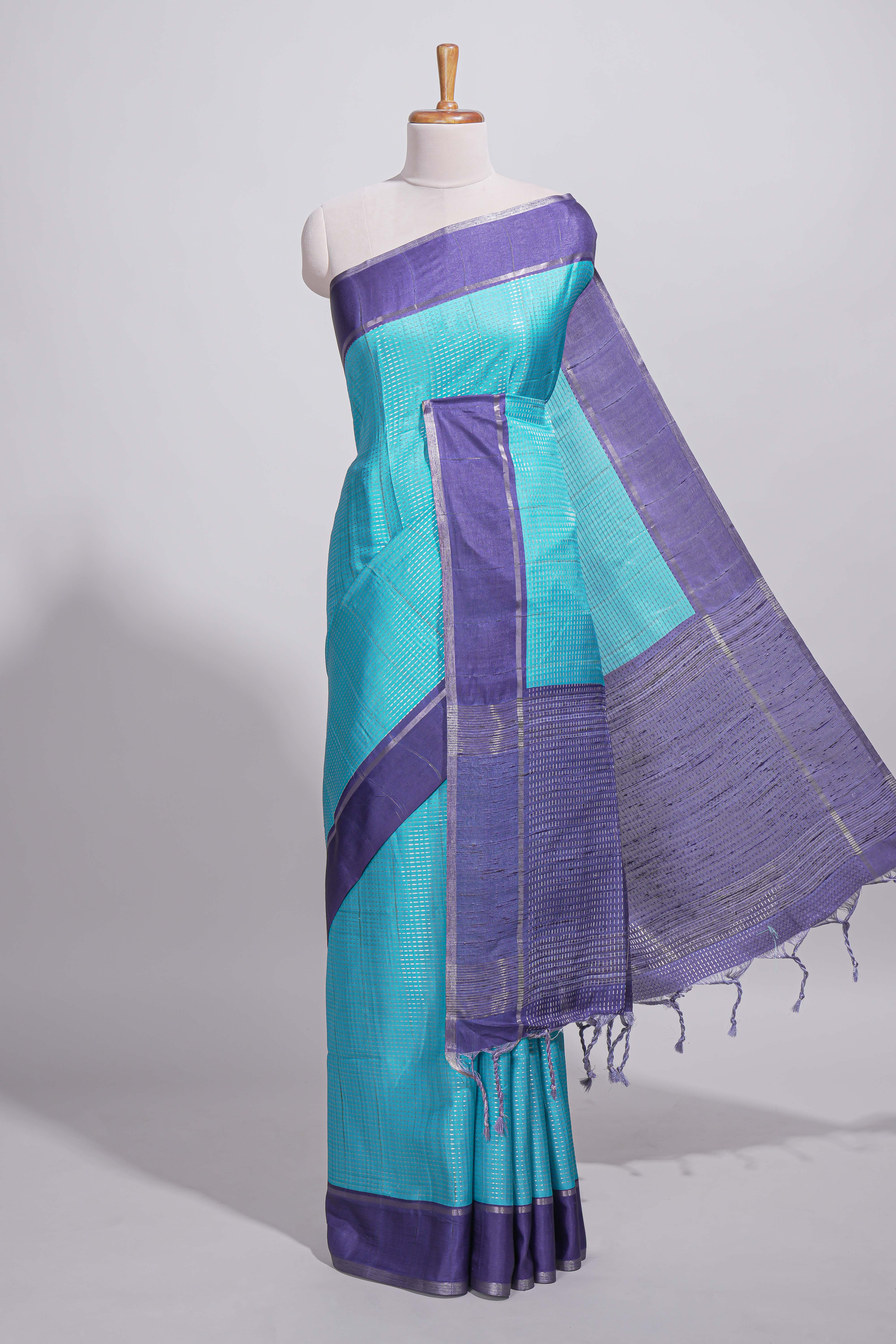 Aqua blue tussar saree with woven checks by rich purple border and matching zari woven palluwith matching blouse piece