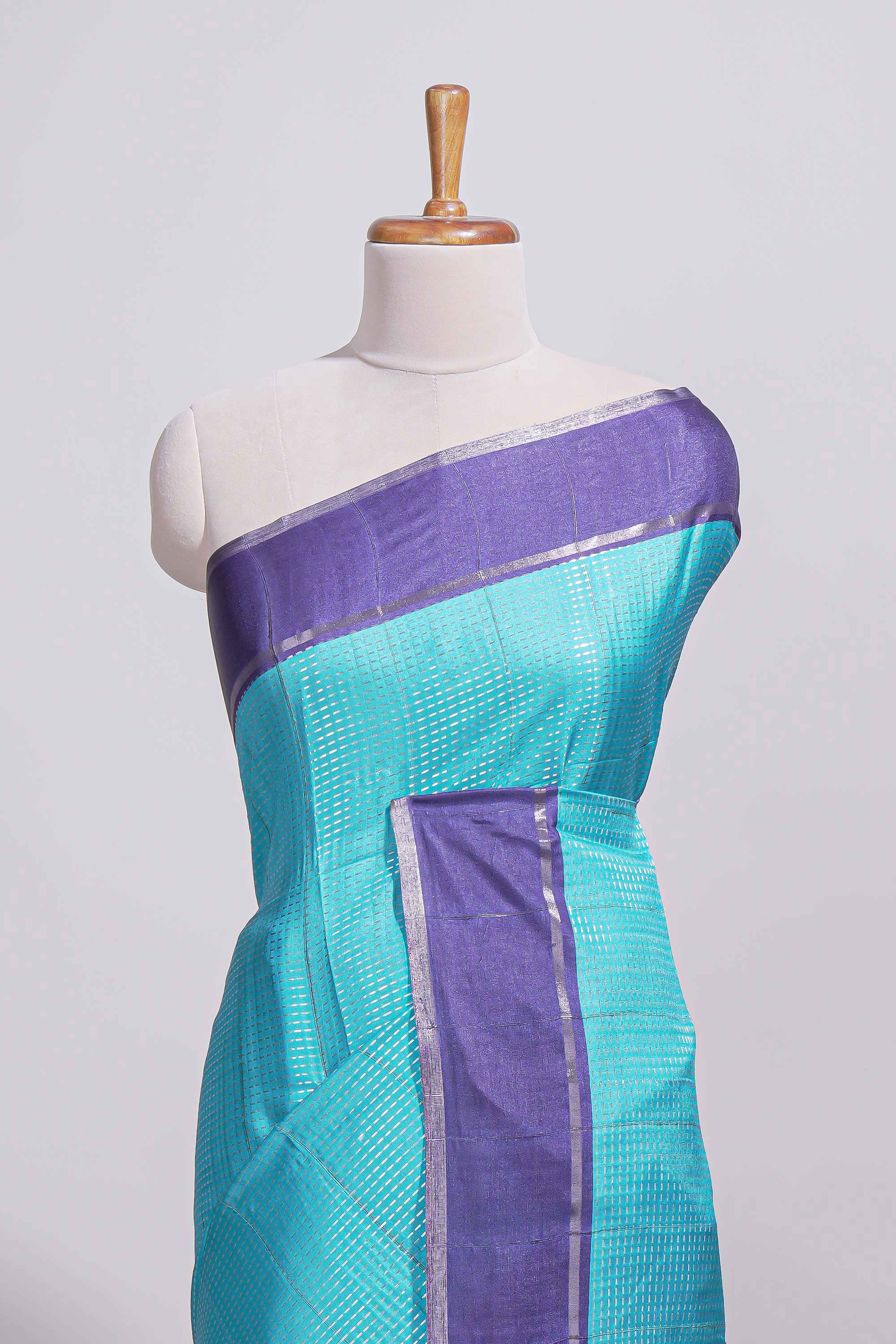Aqua blue tussar saree with woven checks by rich purple border and matching zari woven palluwith matching blouse piece