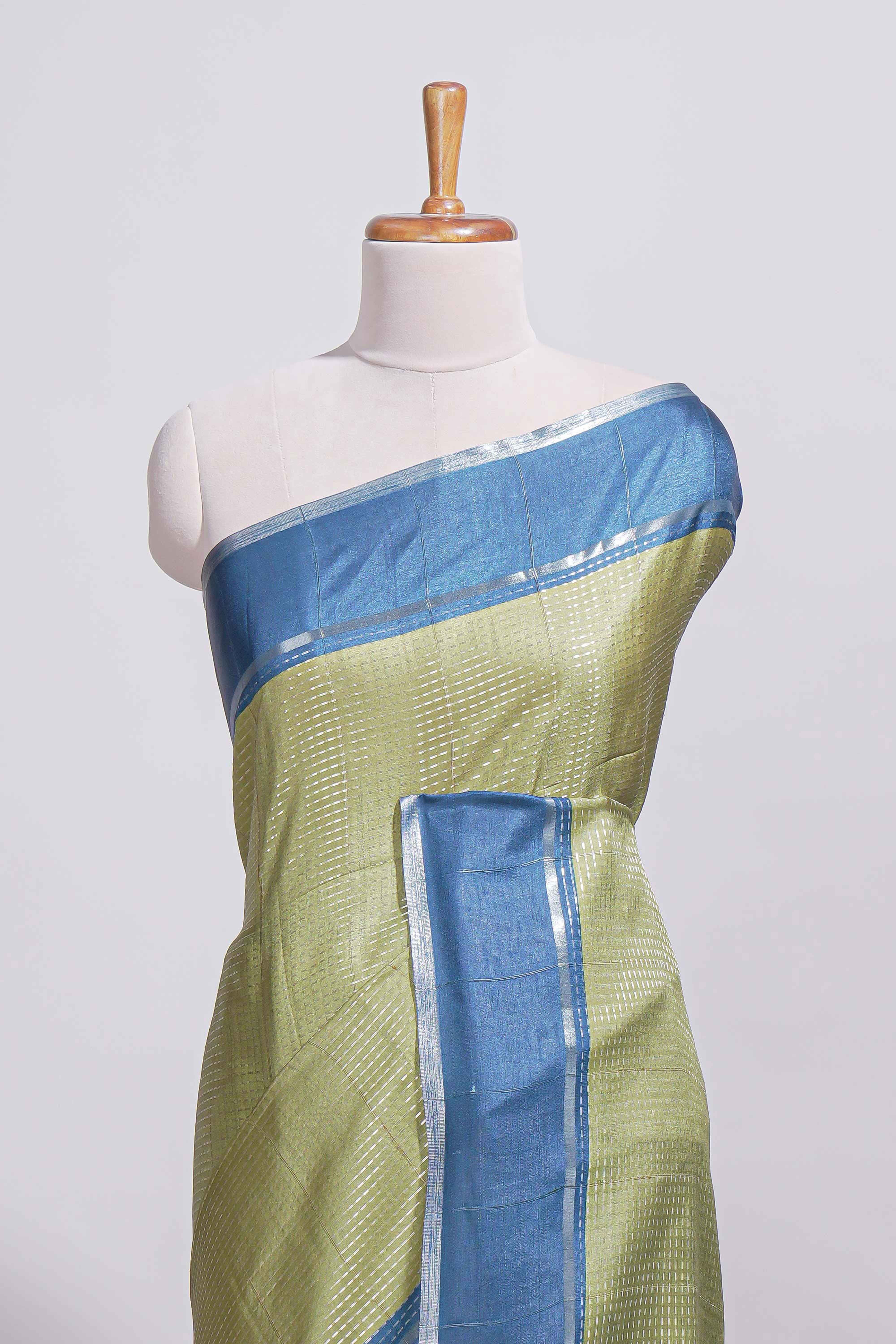 Green tussar saree with woven checks by rich blue border and matching zari woven pallu with contrast blouse piece