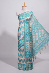 Turquoise color tussar saree body chevron prints floral motifs and printed pallu along with matching blouse
