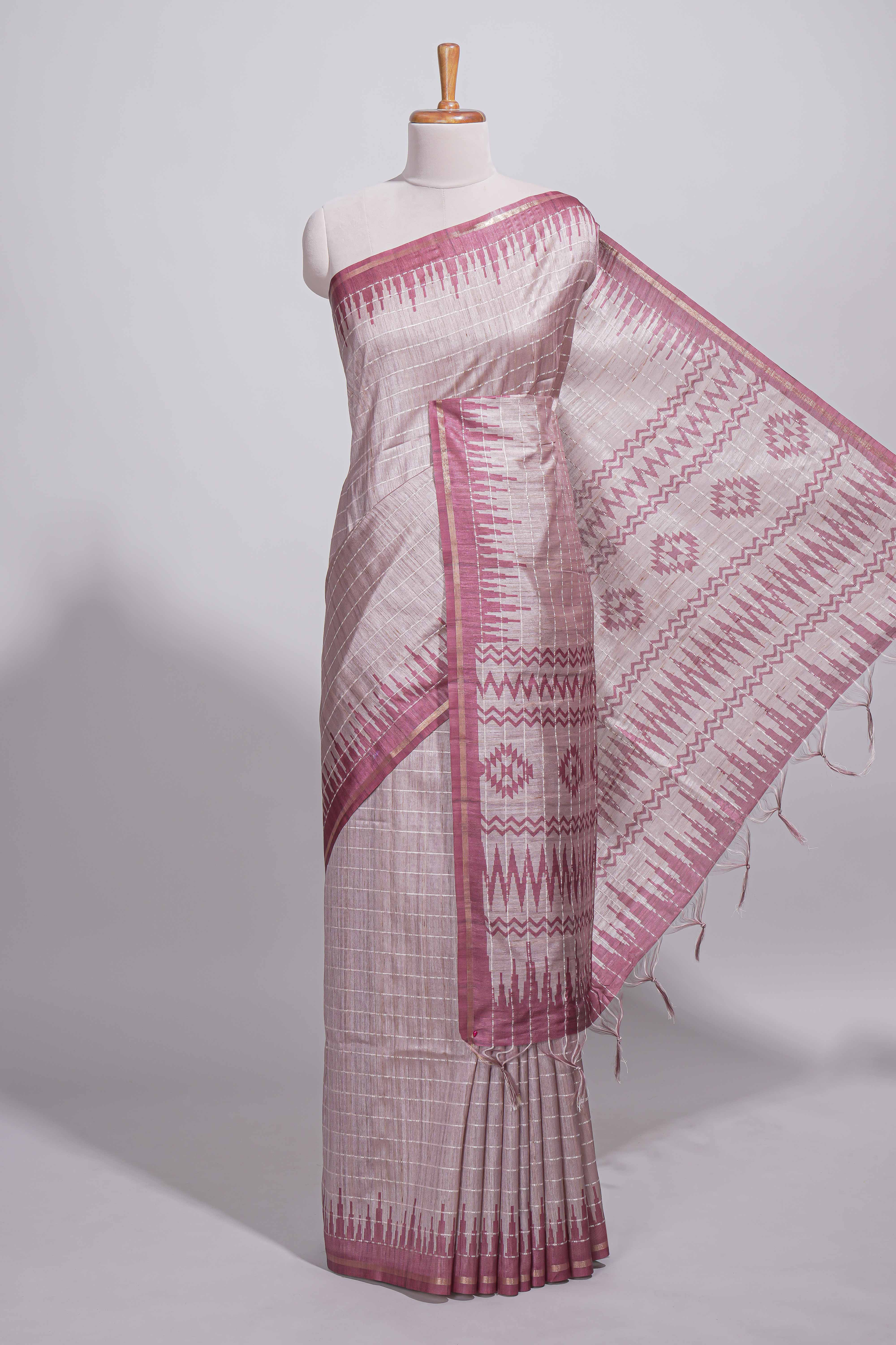 Soft blush pink tussar saree with subtle woven stripes Ikat-inspired border geometric woven pallu with tassels with blouse piece