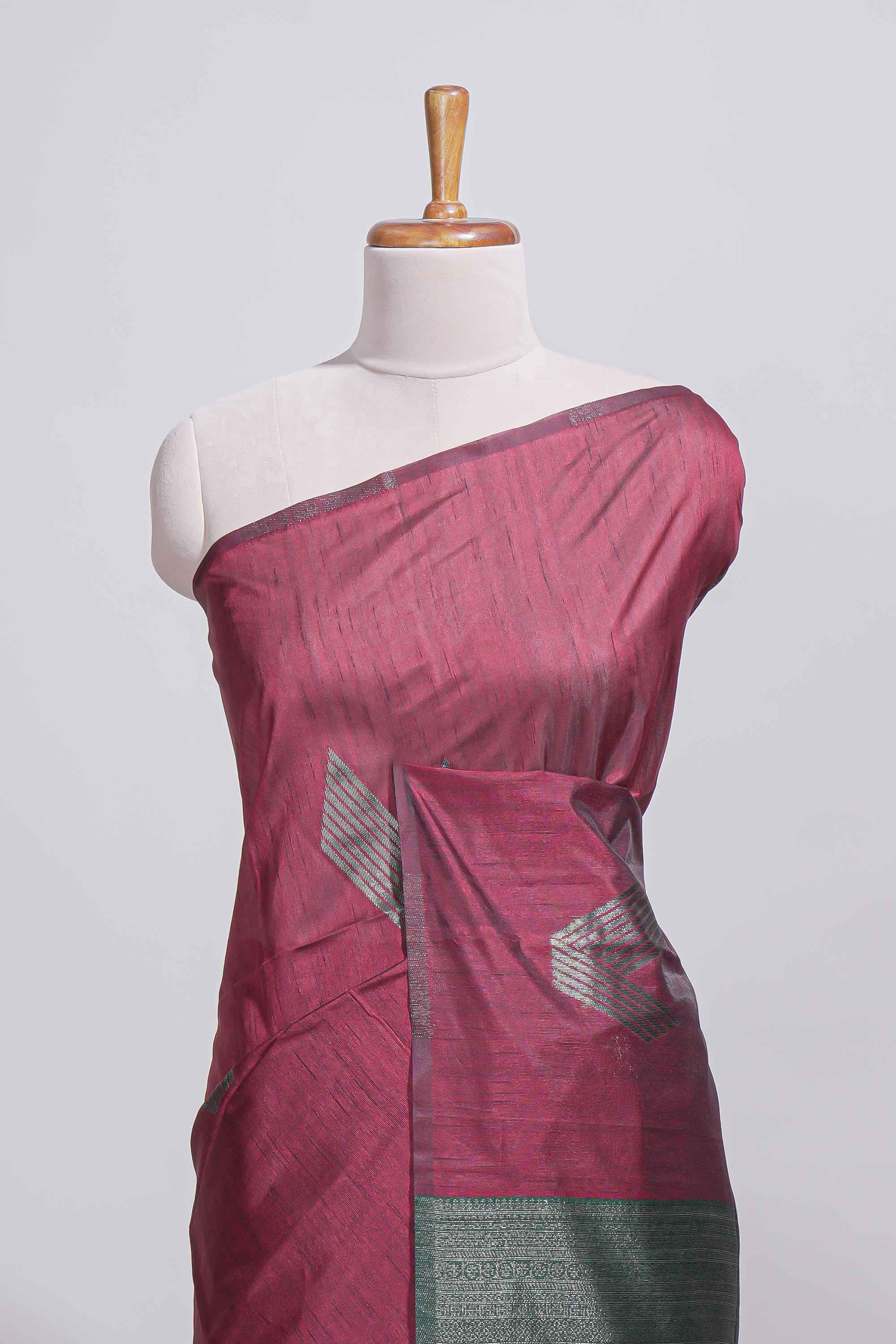 Maroon tussar saree with subtle silver woven motifs paired with a rich zari pallu with tassels with contrast blouse piece