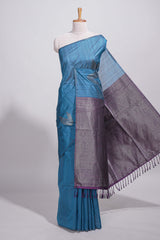 Royal blue tussar saree with subtle silver woven motifs paired with a rich zari pallu with tassels with contrast blouse piece