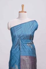 Royal blue tussar saree with subtle silver woven motifs paired with a rich zari pallu with tassels with contrast blouse piece