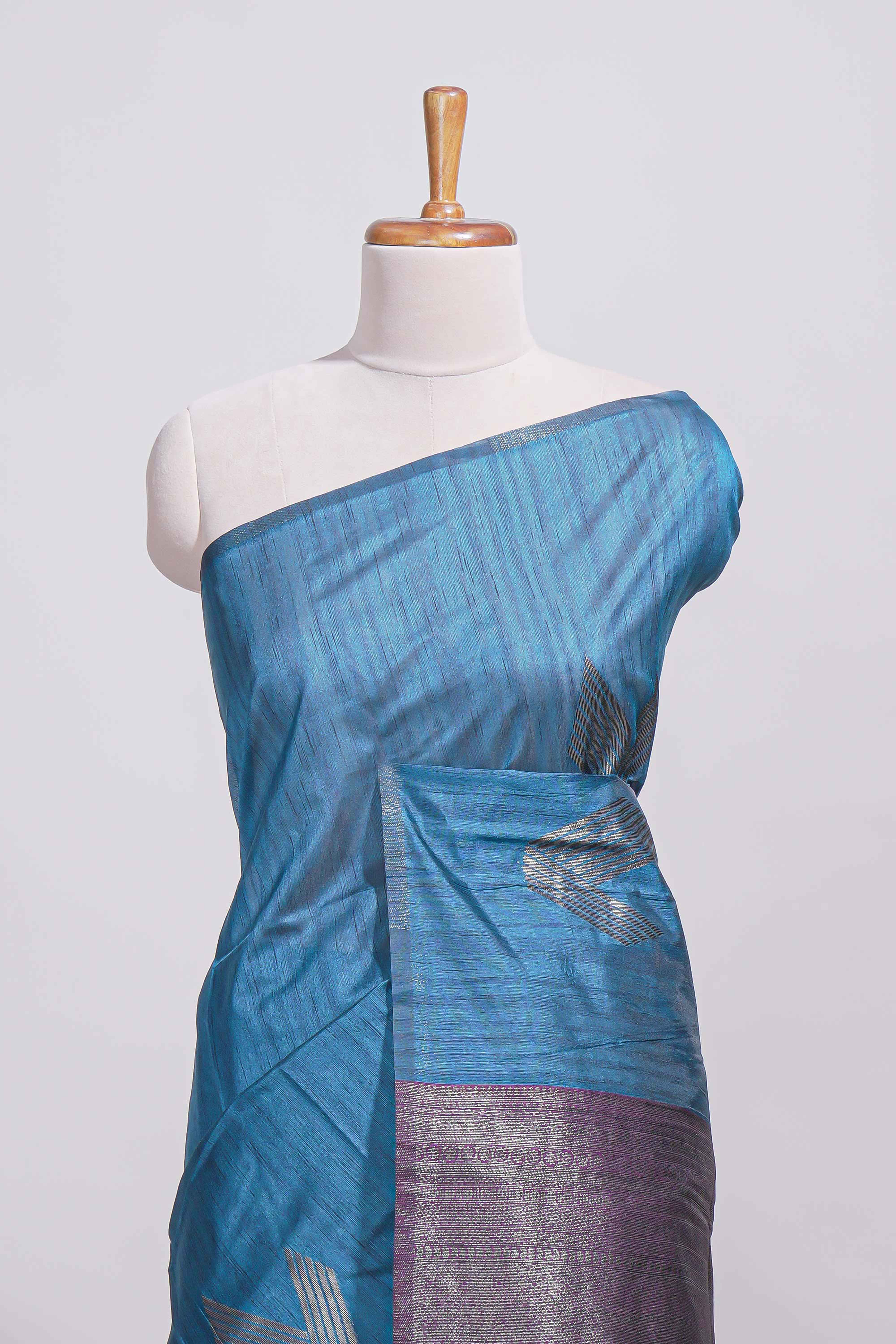 Royal blue tussar saree with subtle silver woven motifs paired with a rich zari pallu with tassels with contrast blouse piece