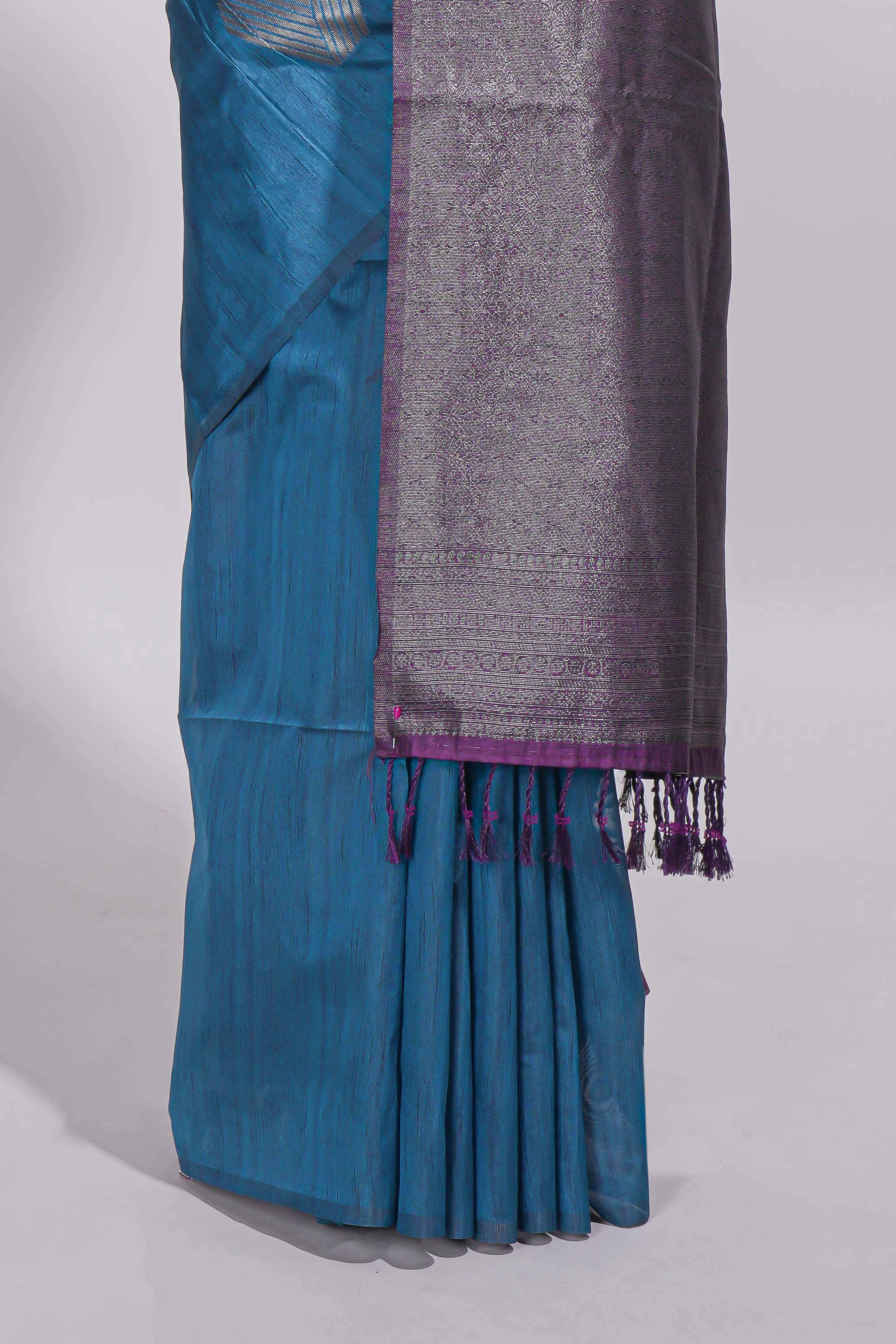 Royal blue tussar saree with subtle silver woven motifs paired with a rich zari pallu with tassels with contrast blouse piece